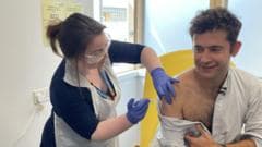 First person gets new experimental vaccine for Ebola
