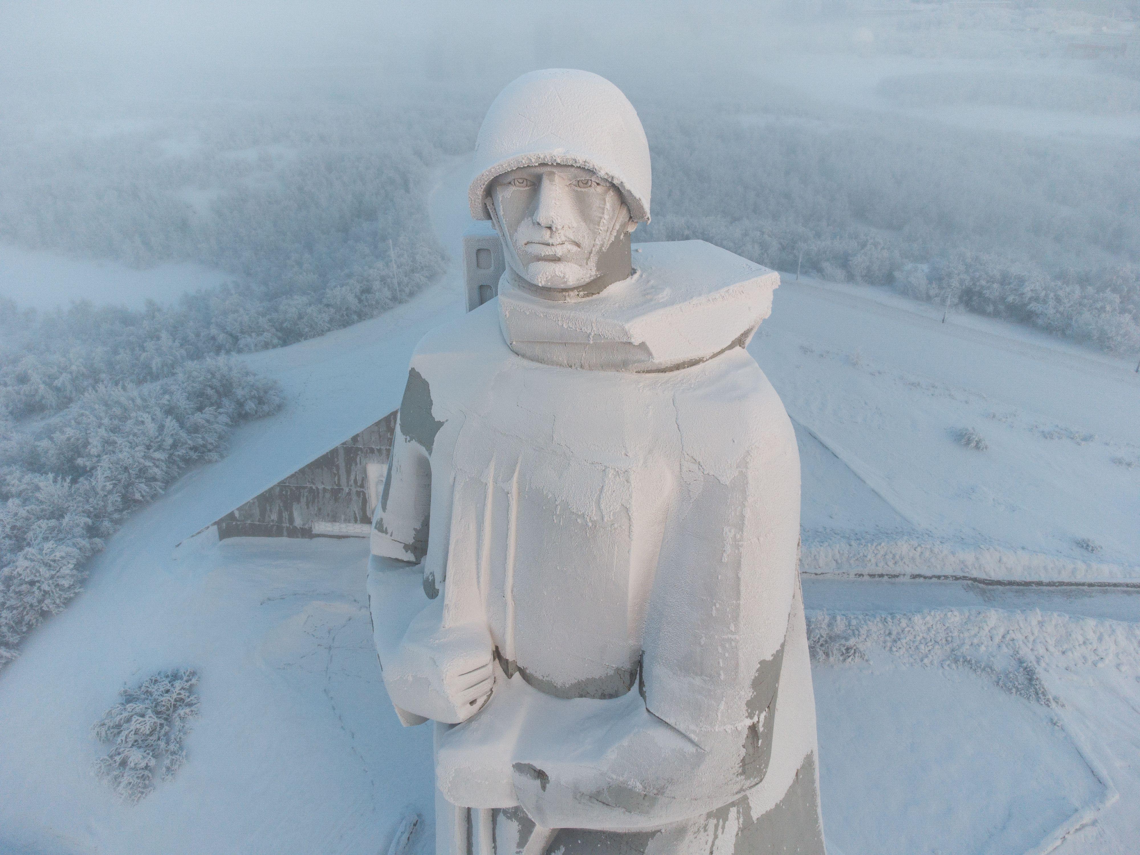 Aerial view of the snow-covered Alyosha monument in Murmansk during winter.