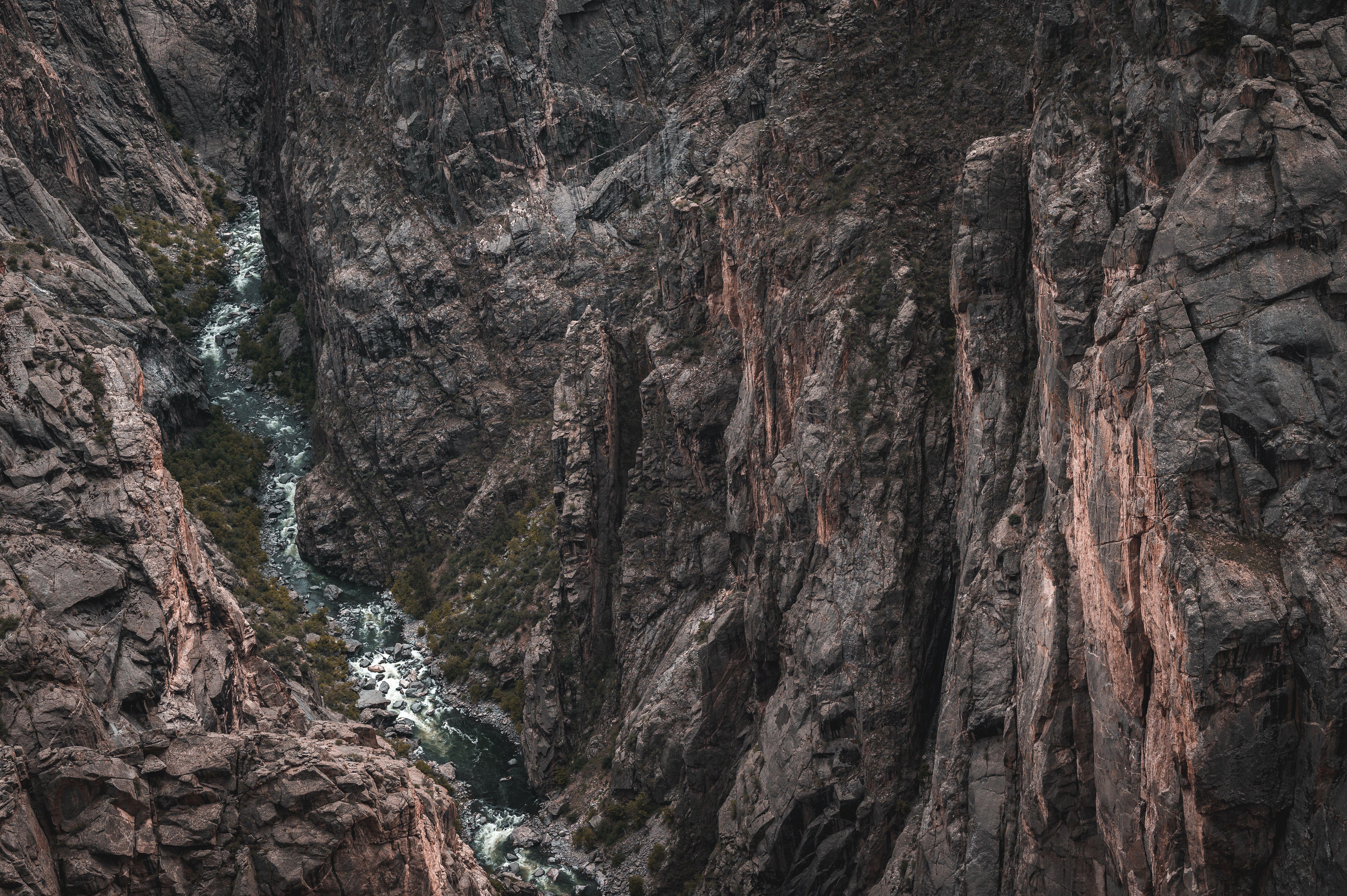 Aerial view of the rugged Black Canyon showcasing dramatic geological formations and a flowing river.