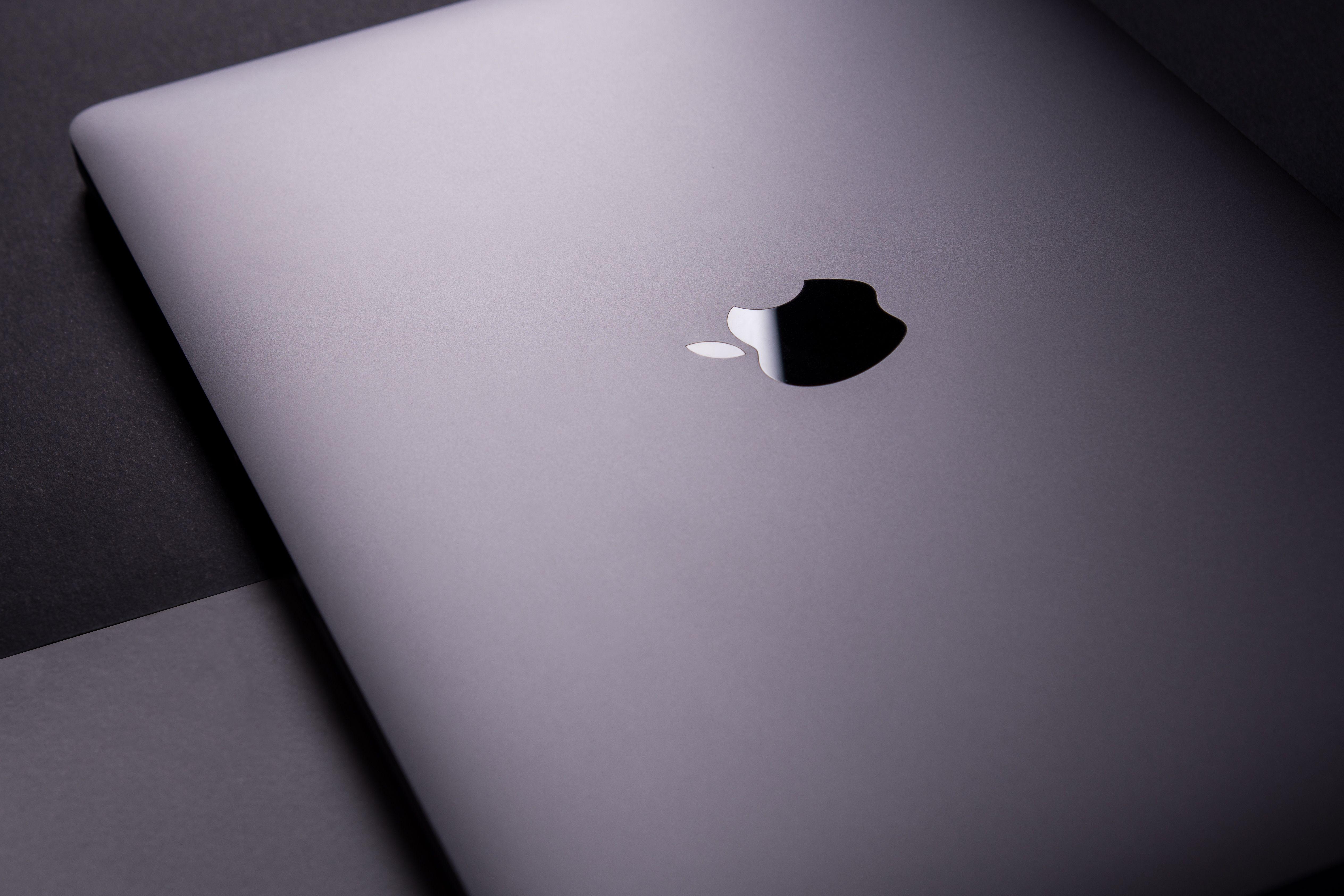 Close-up of a sleek, modern laptop featuring a minimalist design on a dark surface.