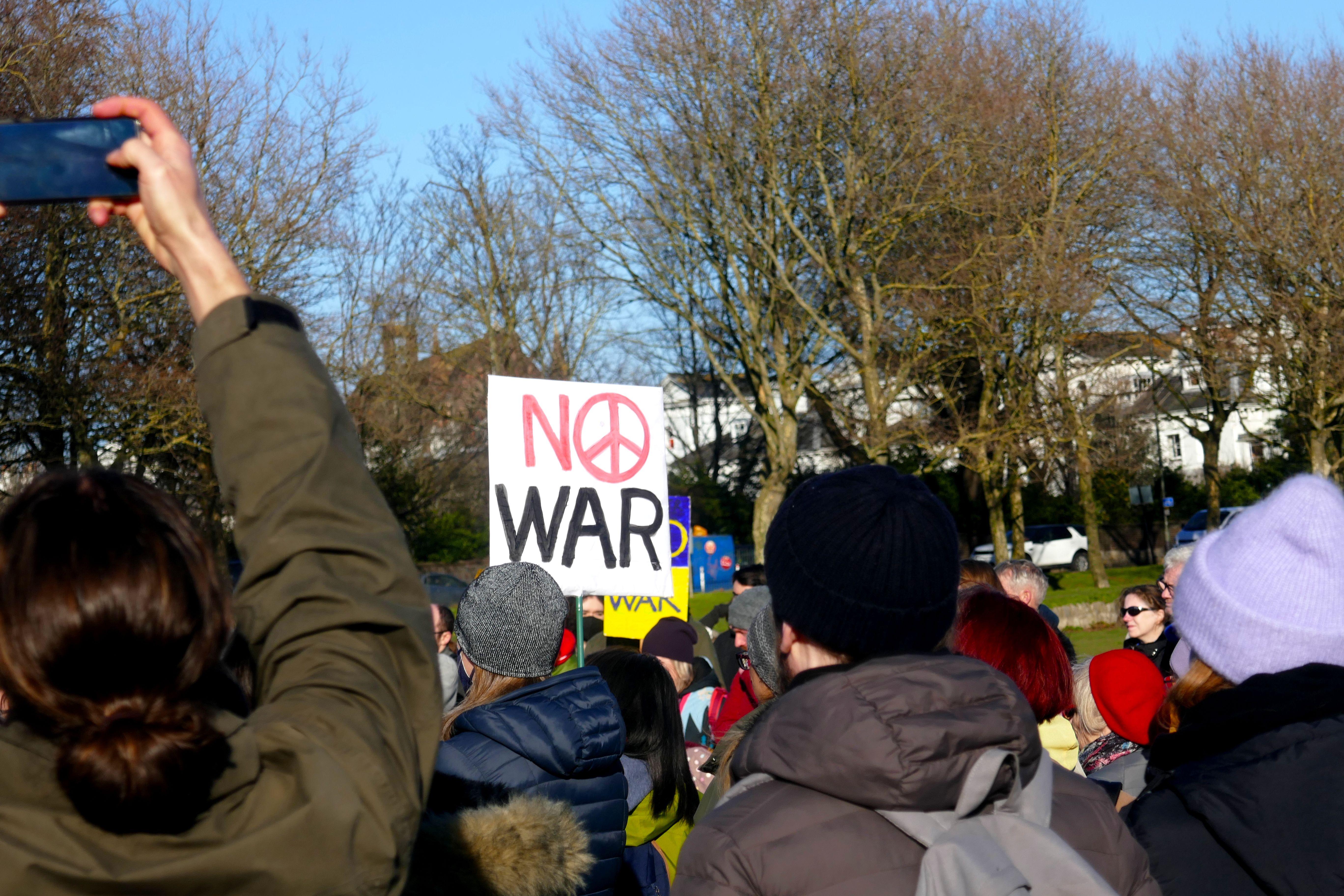 Crowd in Brighton, England, protesting against war with signs and peaceful demonstration.