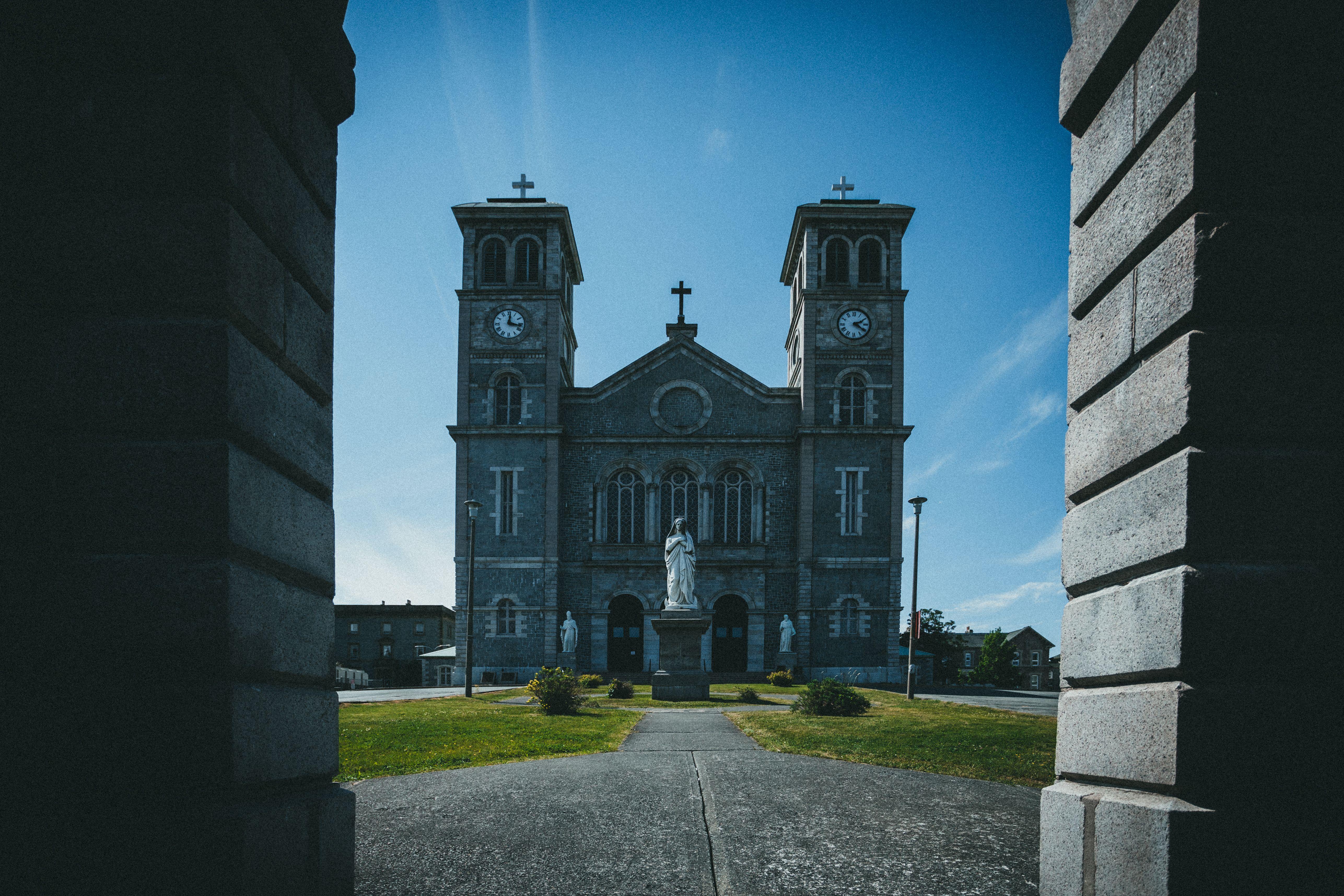 Historic basilica in Newfoundland, featuring Gothic architecture and twin clock towers.