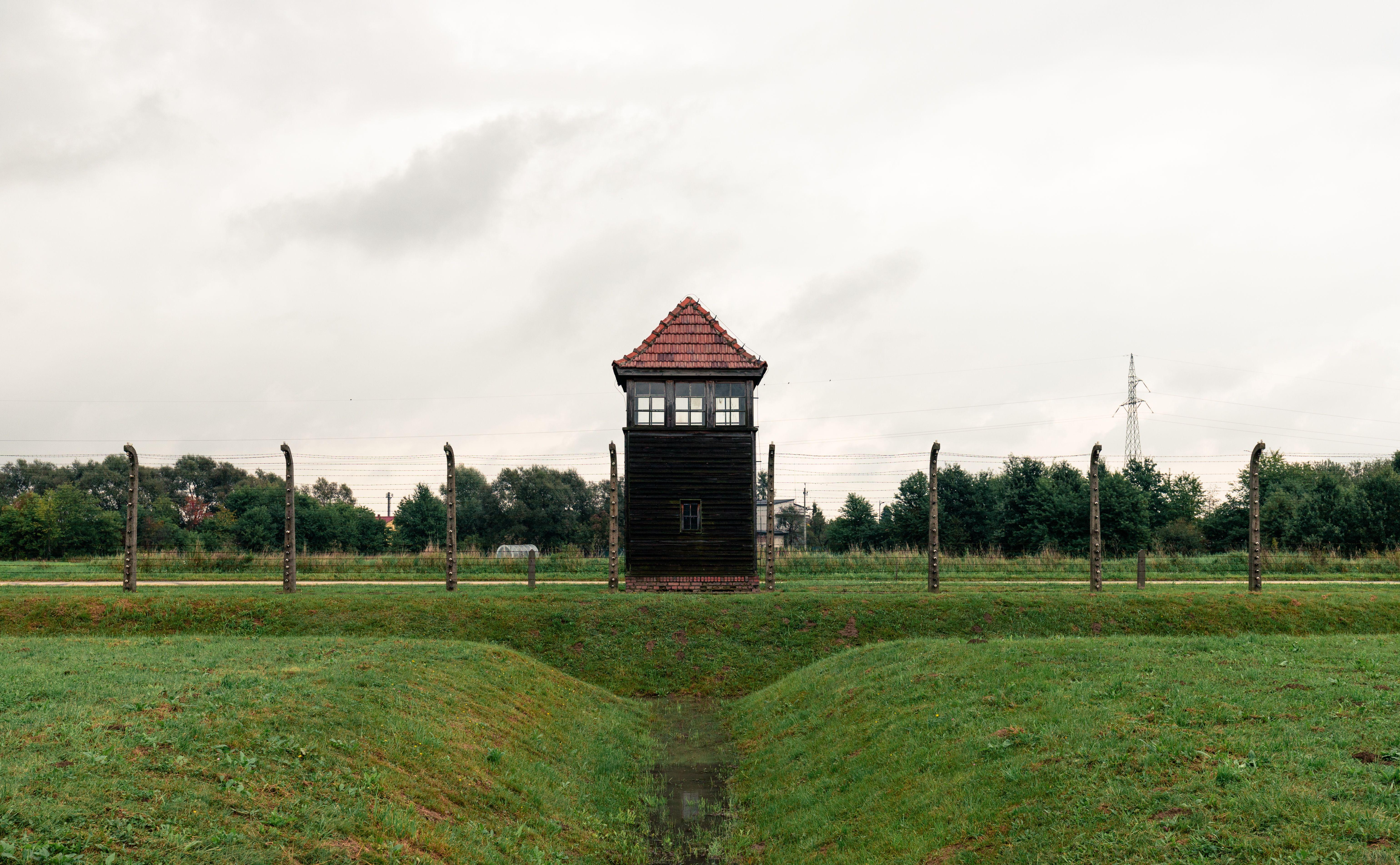 A solemn view of a guard tower at Auschwitz concentration camp, reflecting on history.