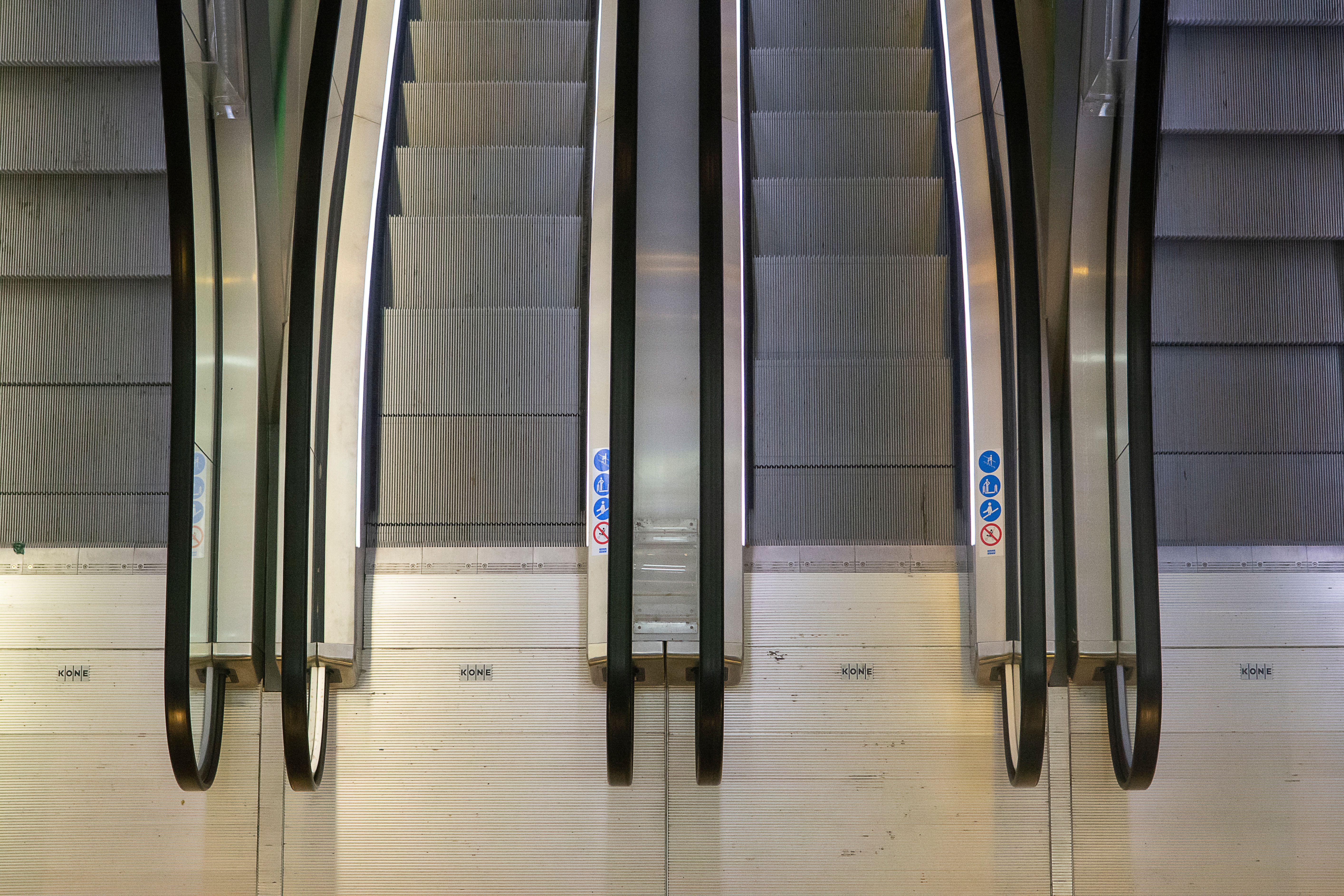 Aerial perspective of escalators in a Rotterdam building, showcasing industrial design and symmetry.