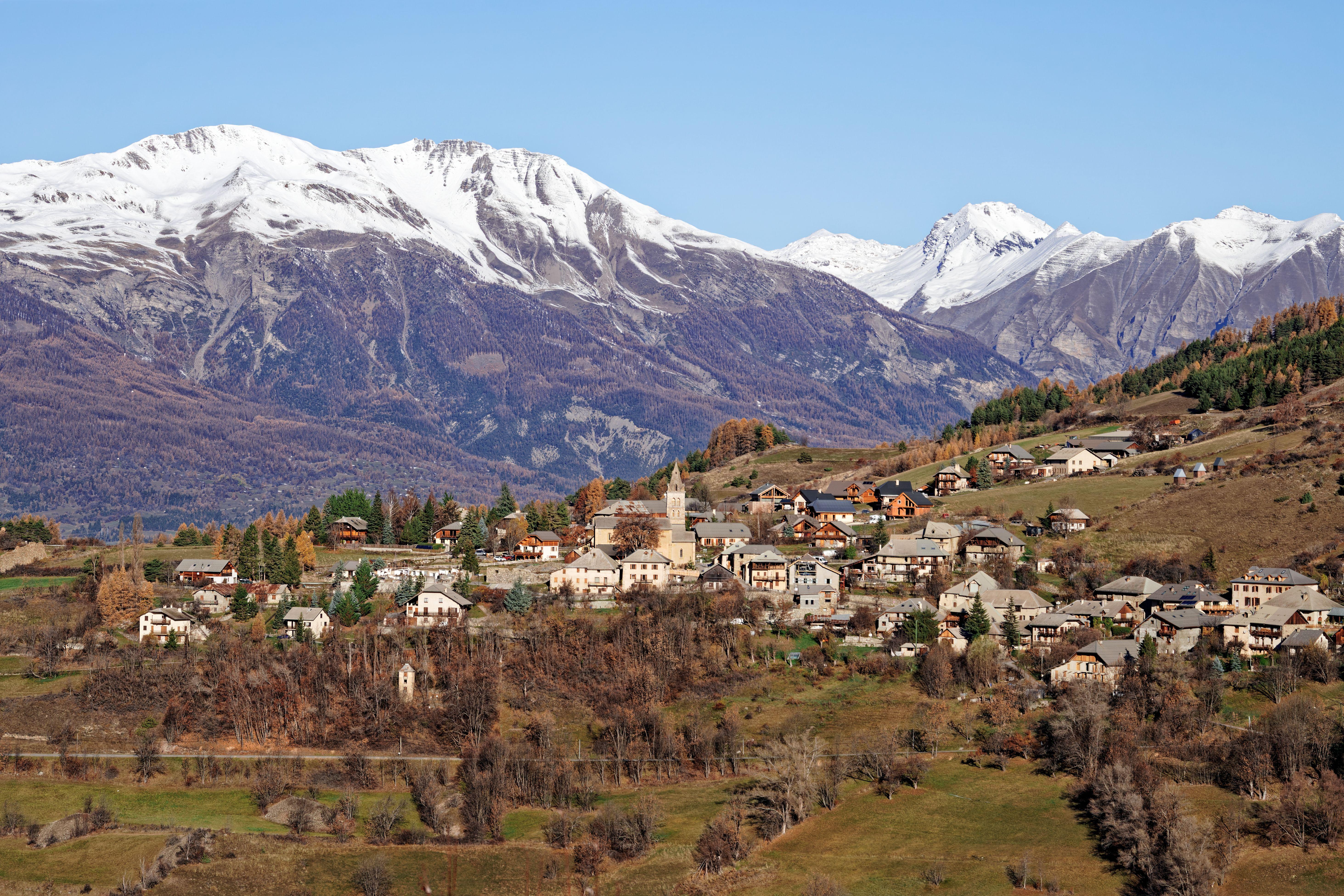 Charming village nestled in the Alps with stunning mountain backdrop in Provence, France.