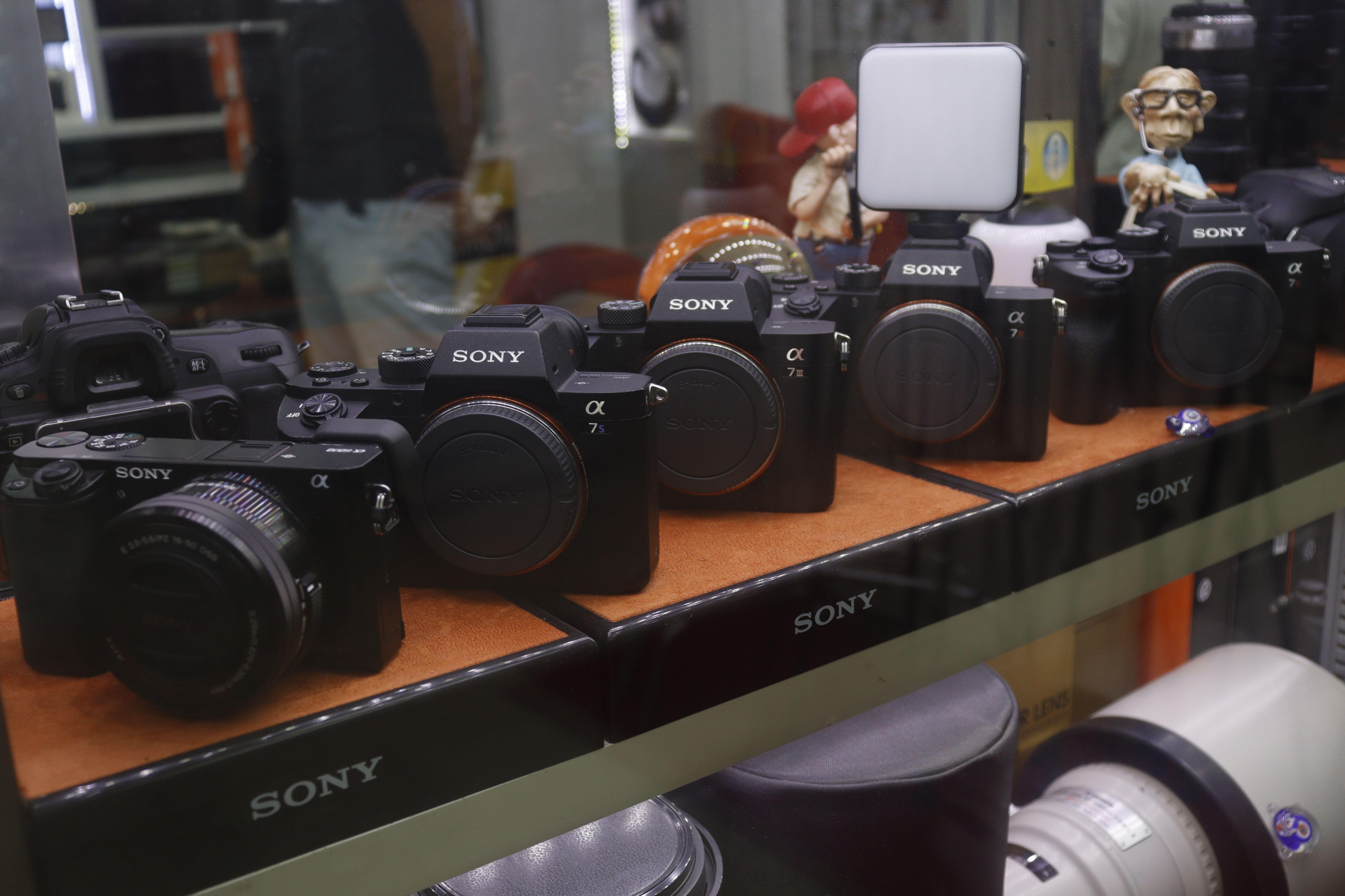Showcase of Sony cameras in a retail store display.