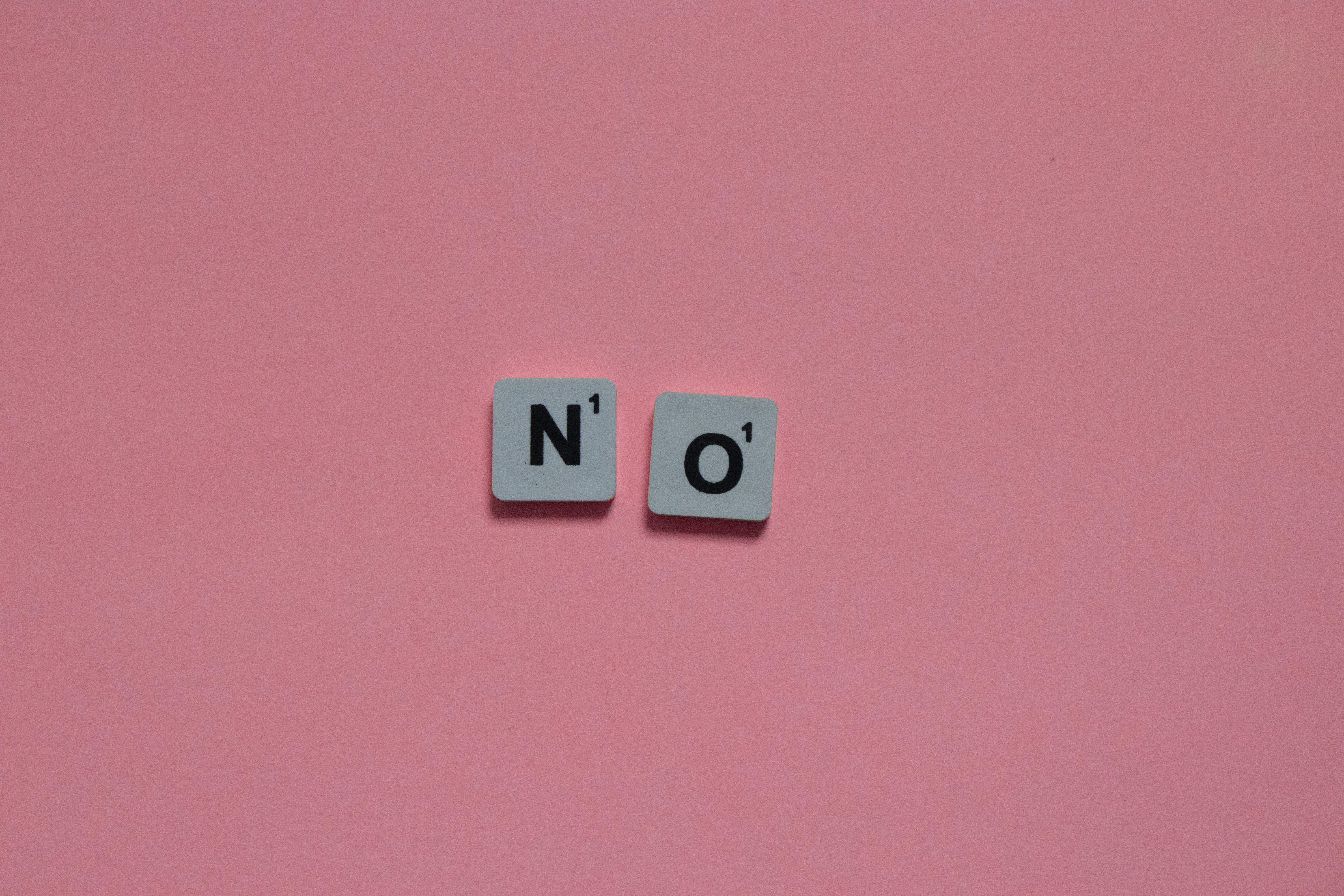 Letters N and O from a word game on a pink background. Minimalist and playful.