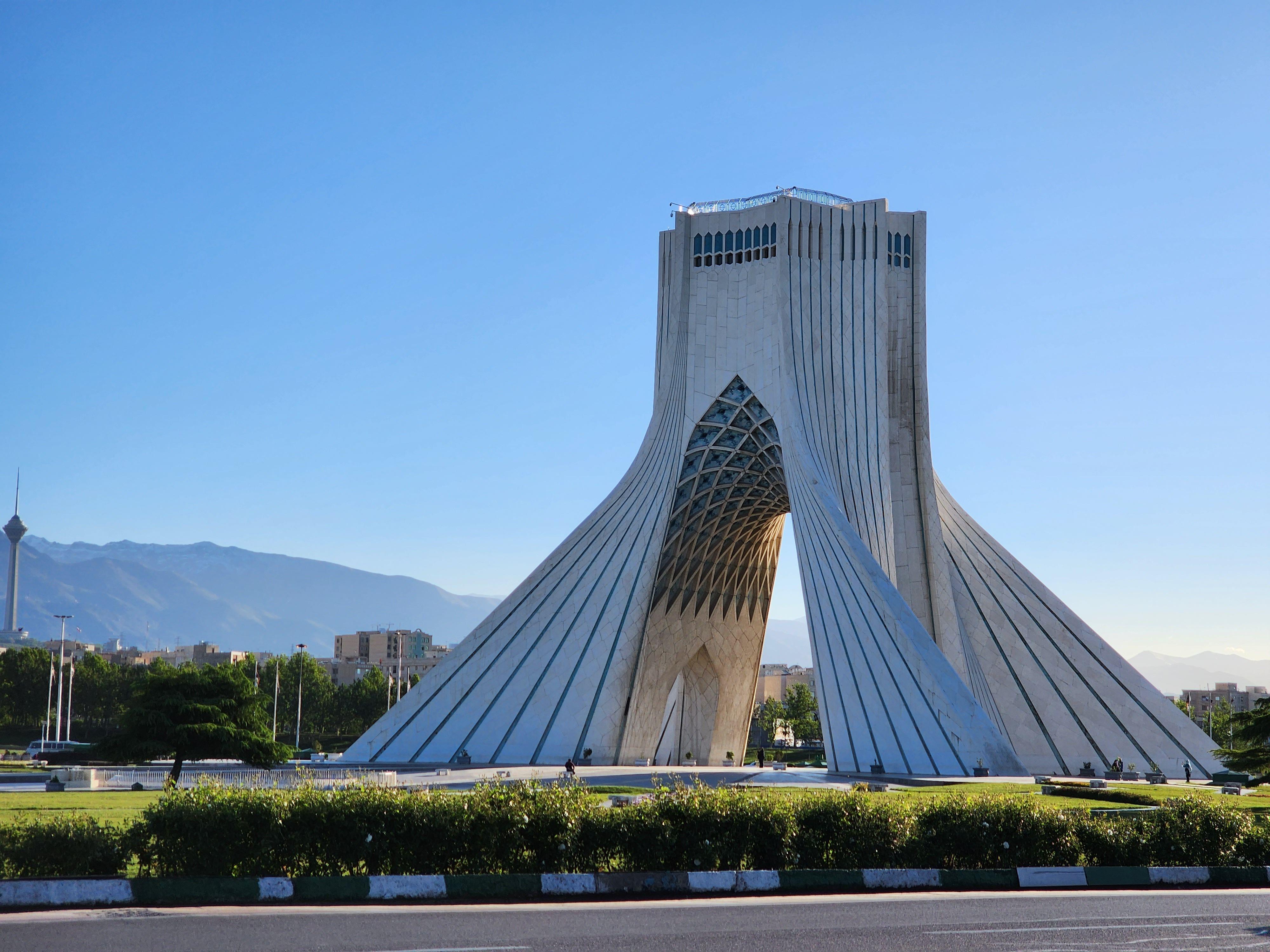 Iconic Azadi Tower in Tehran, Iran, under clear blue skies, perfect for travel inspiration.