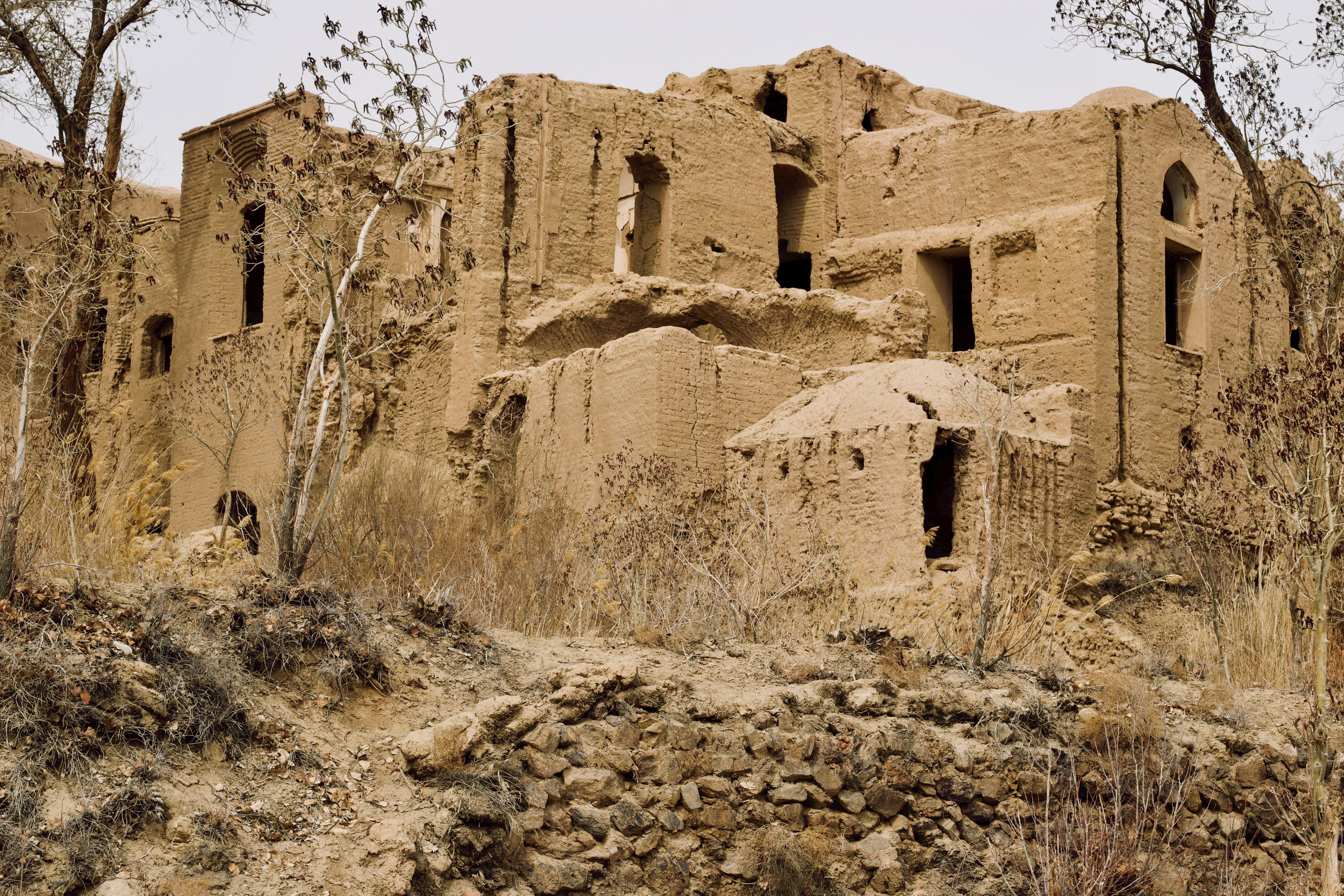 Captivating image of the historic abandoned mud-brick structures in Kharanaq, Yazd Province, Iran.