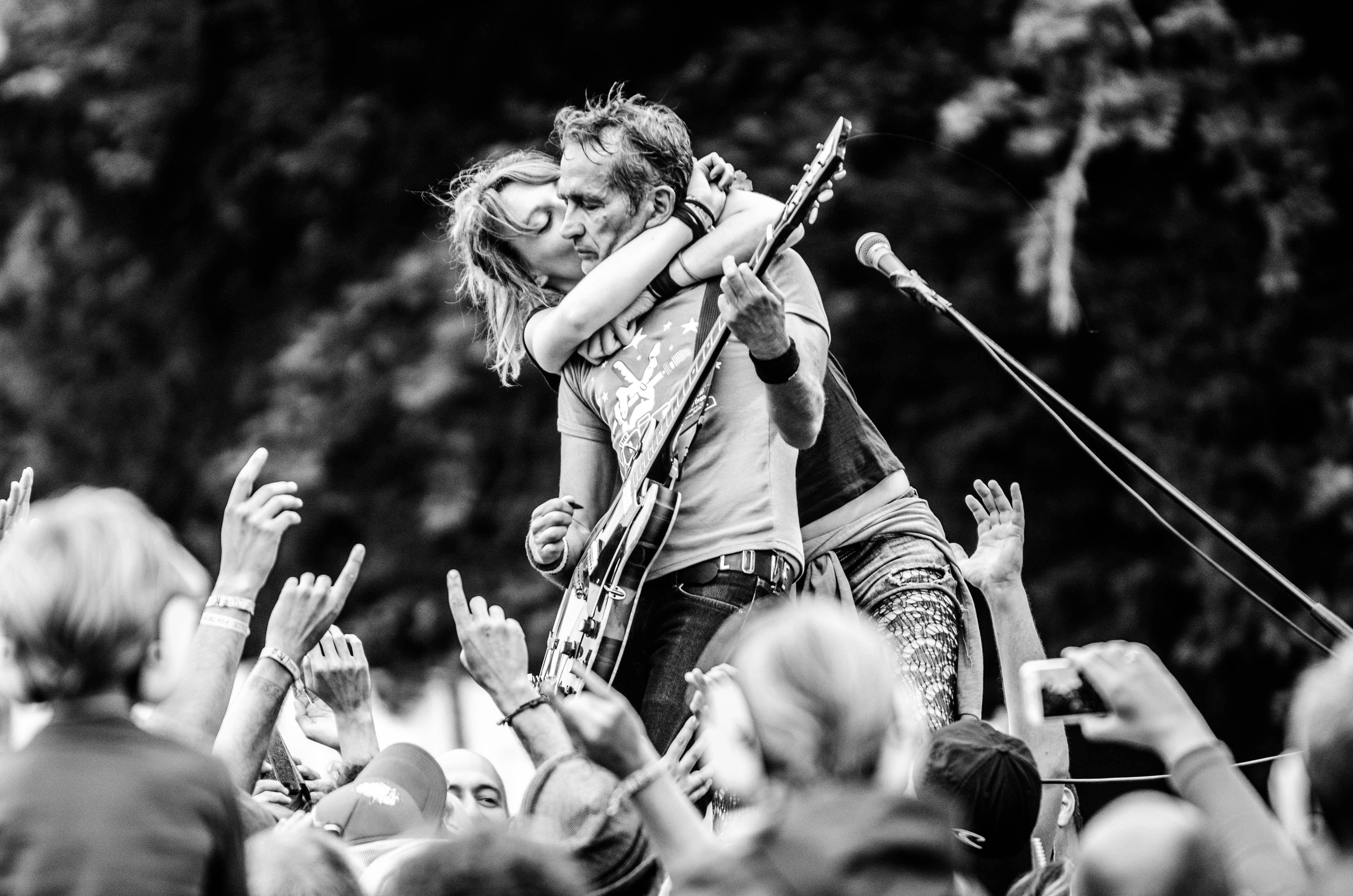 Energetic live music performance with crowd interaction at a rock concert.