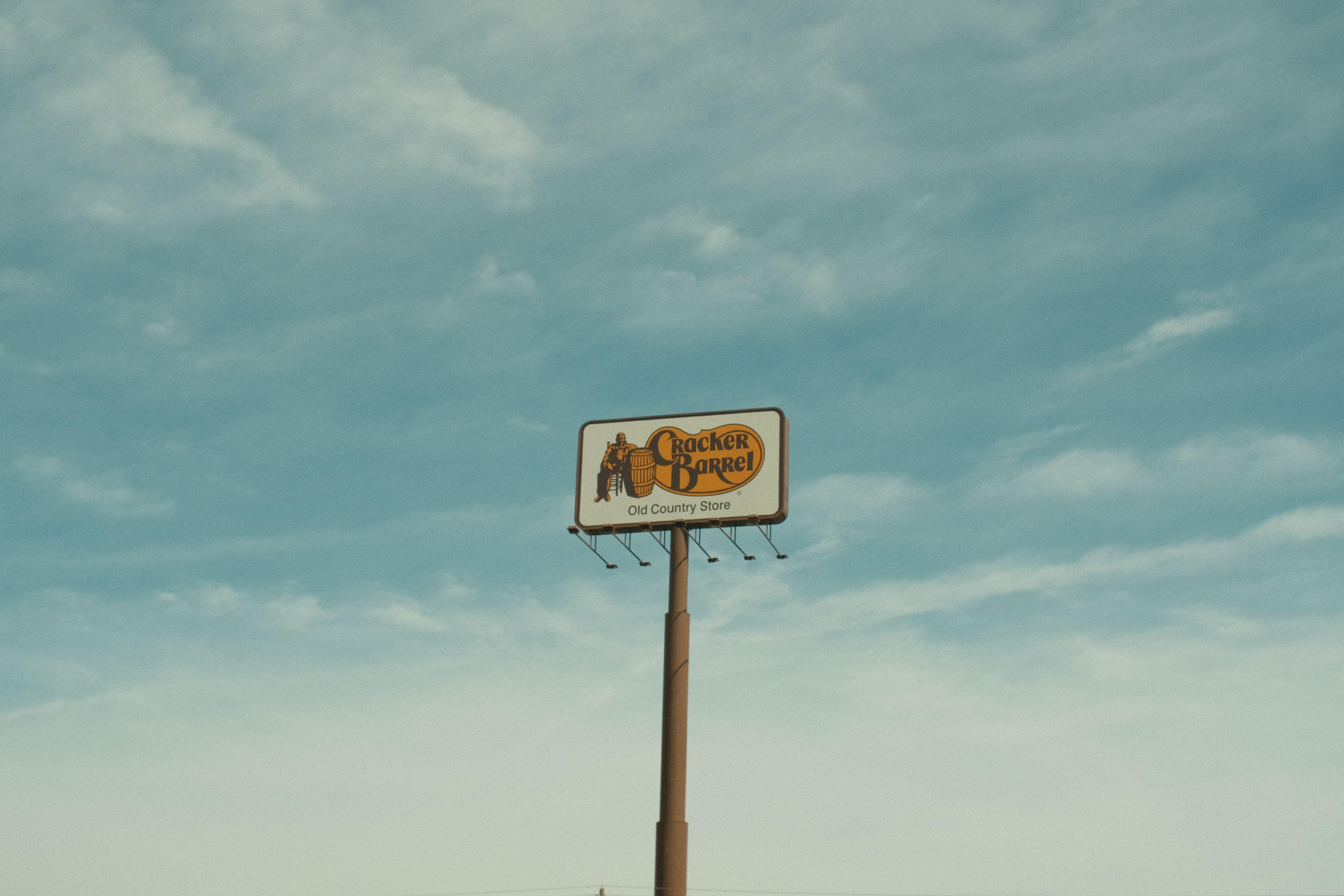 Cracker Barrel signpost with a clear blue sky background in Valdosta, GA, USA.