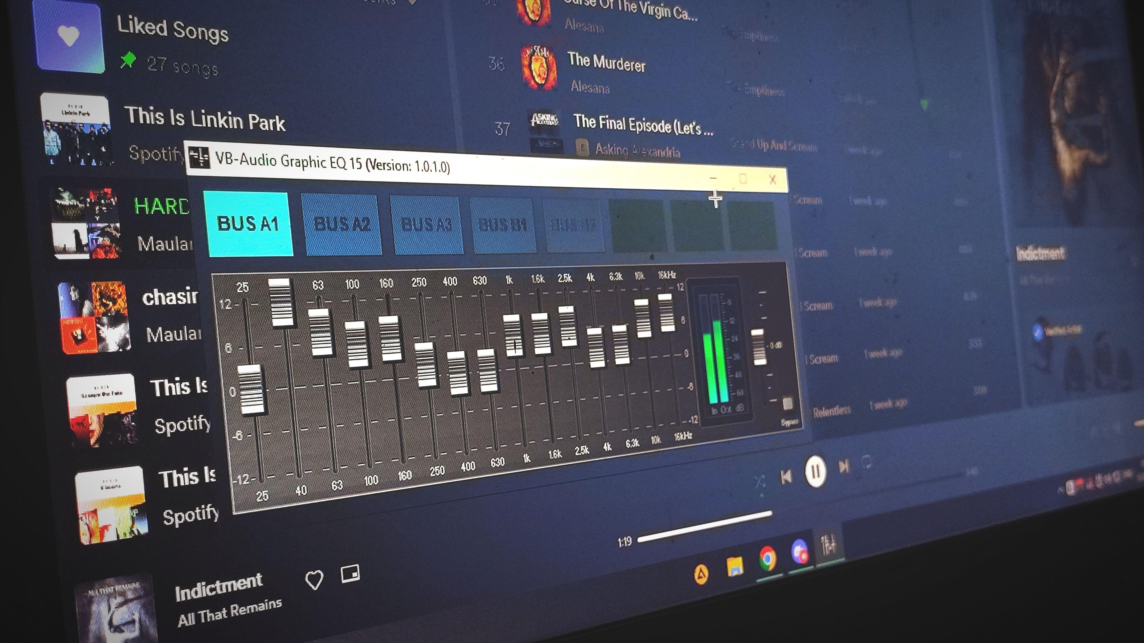 Close-up of a digital audio graphic equalizer on a laptop screen for music editing.