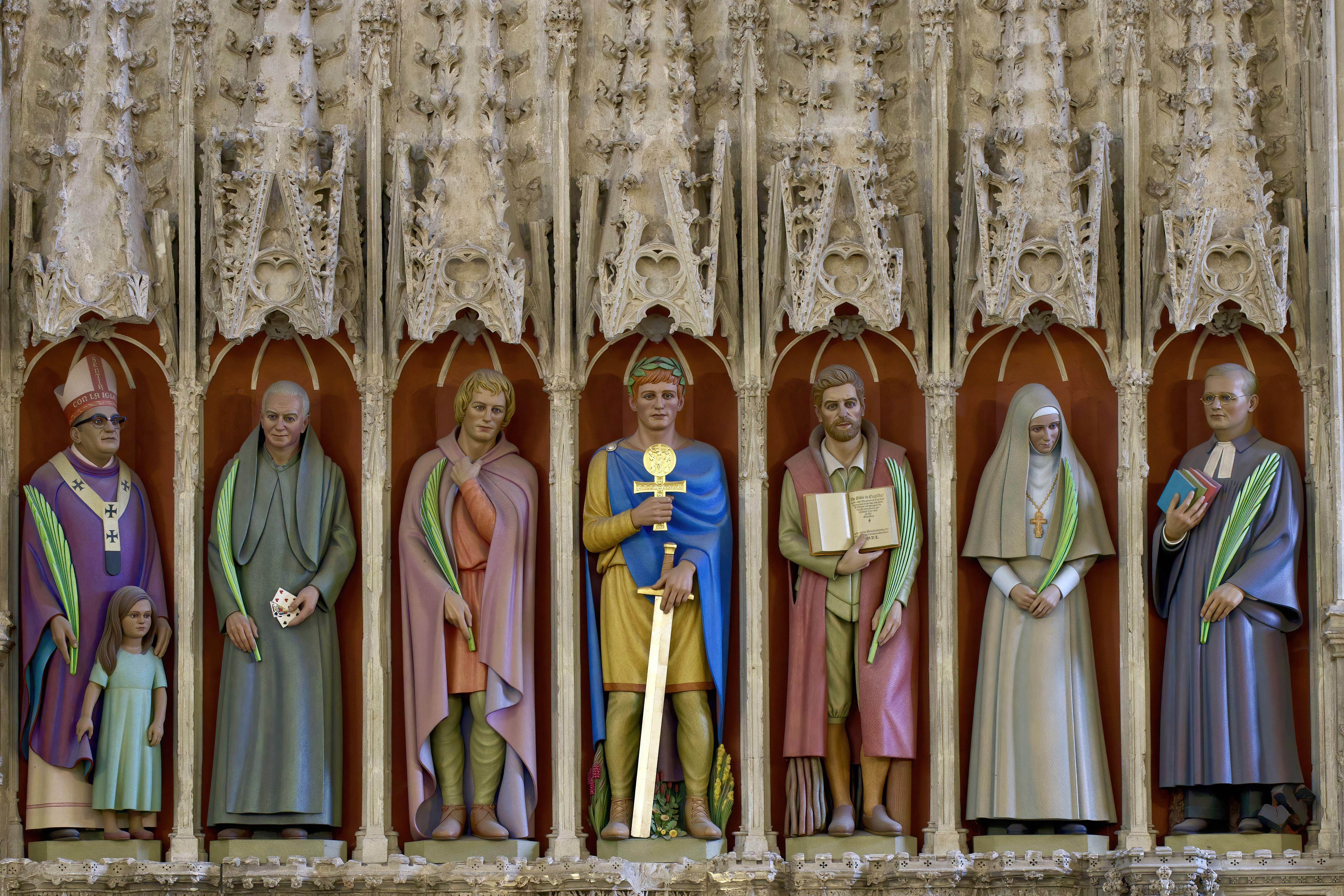 Vibrant painted statues in a gothic cathedral, reflecting religious history.