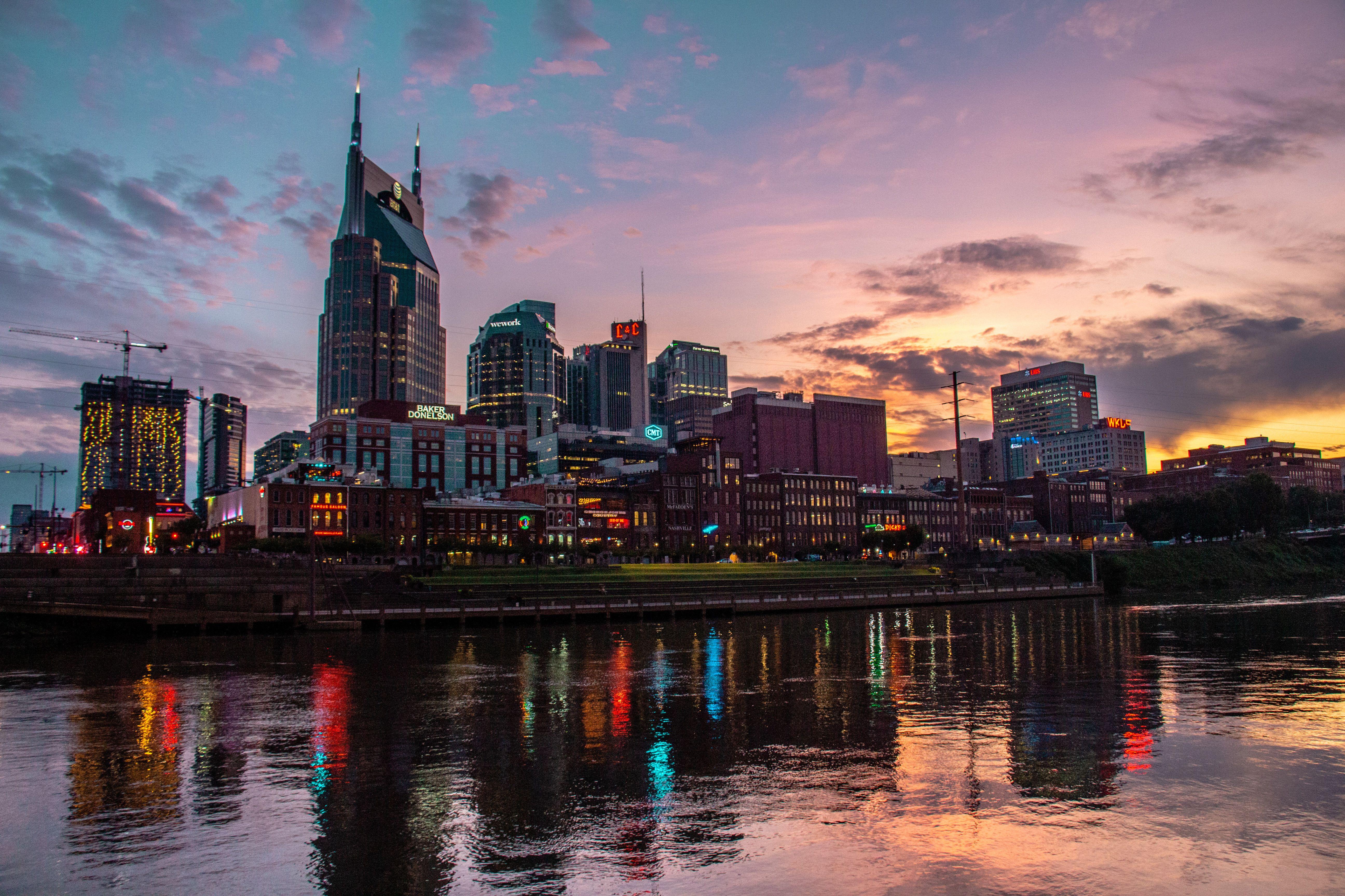 Captivating view of Nashville's skyline reflected on the river at sunset, showcasing urban architecture.