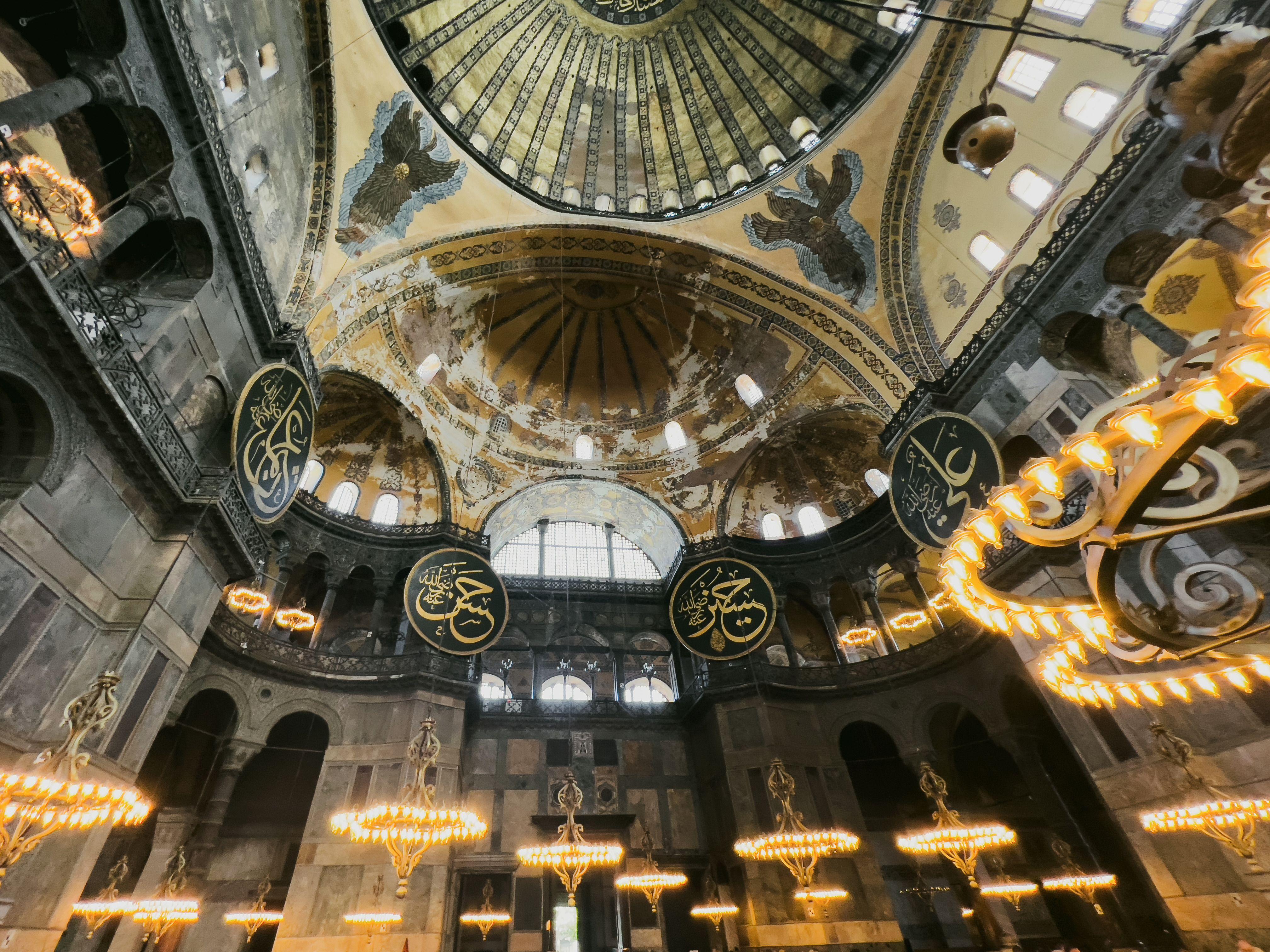 Captivating interior view of Hagia Sophia Mosque in Istanbul, showcasing intricate dome architecture and decorative elements.