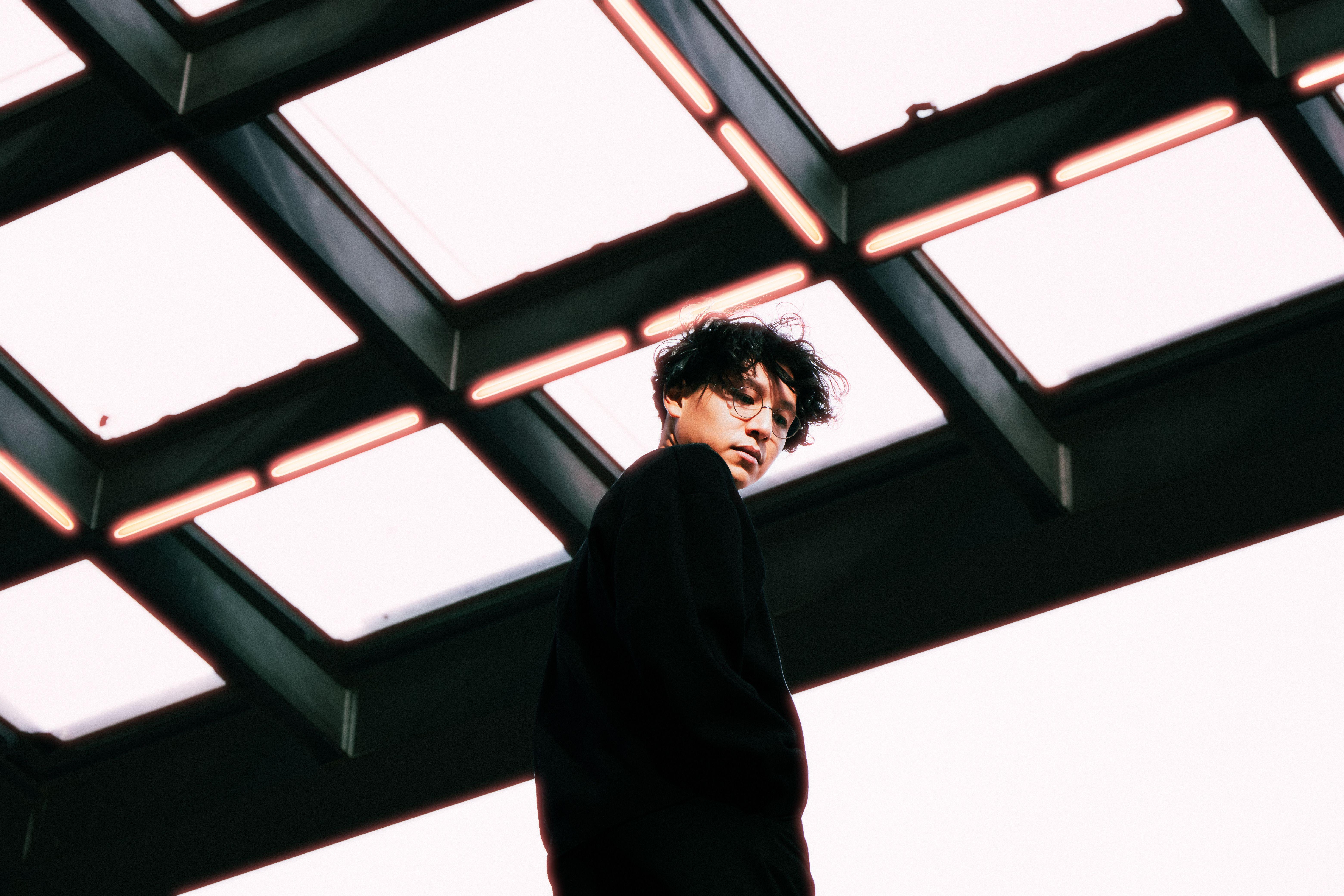 Stylish portrait of a person under a glass ceiling in Berlin, featuring modern architecture.