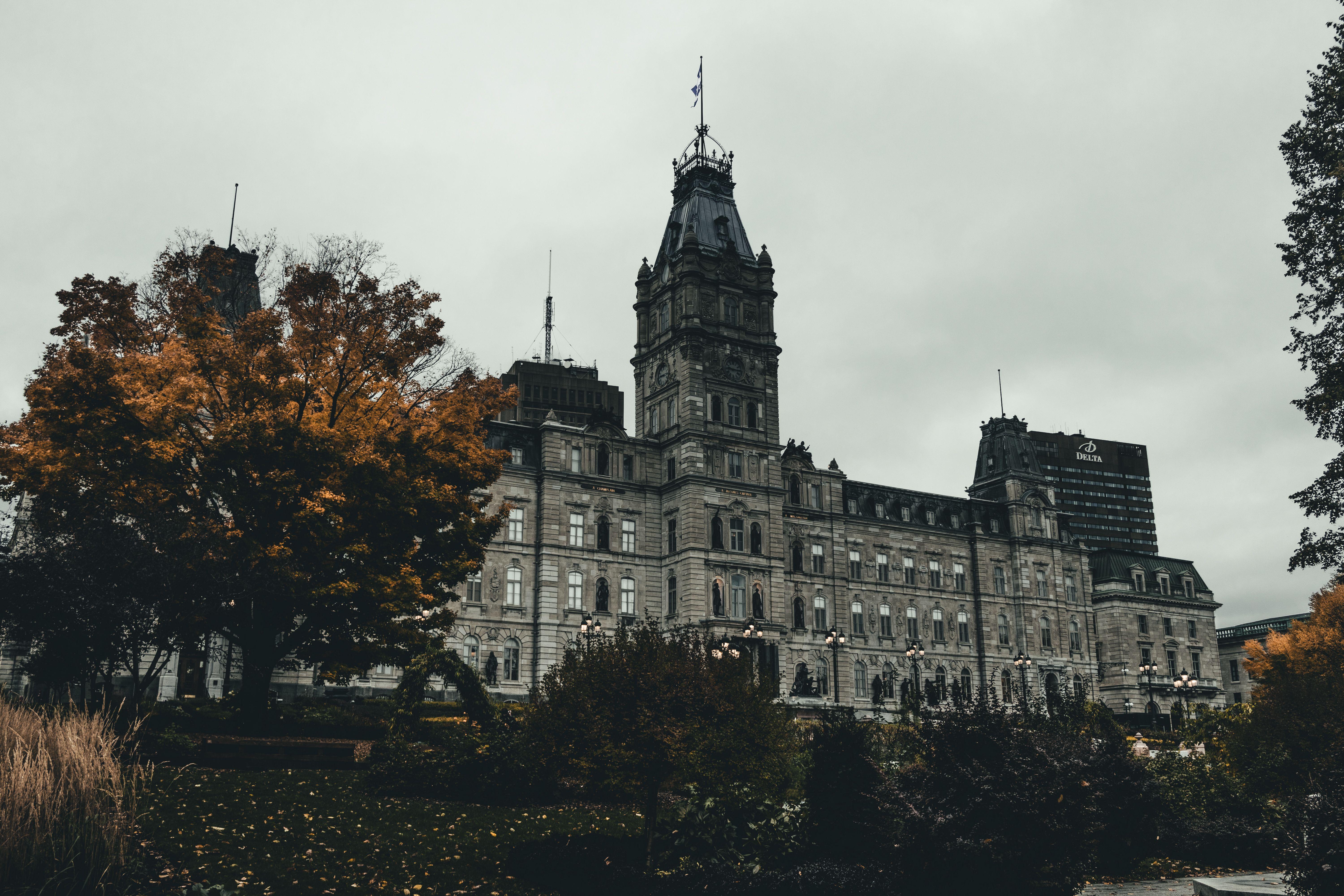 A stunning view of the Quebec City Parliament Building surrounded by autumn foliage.