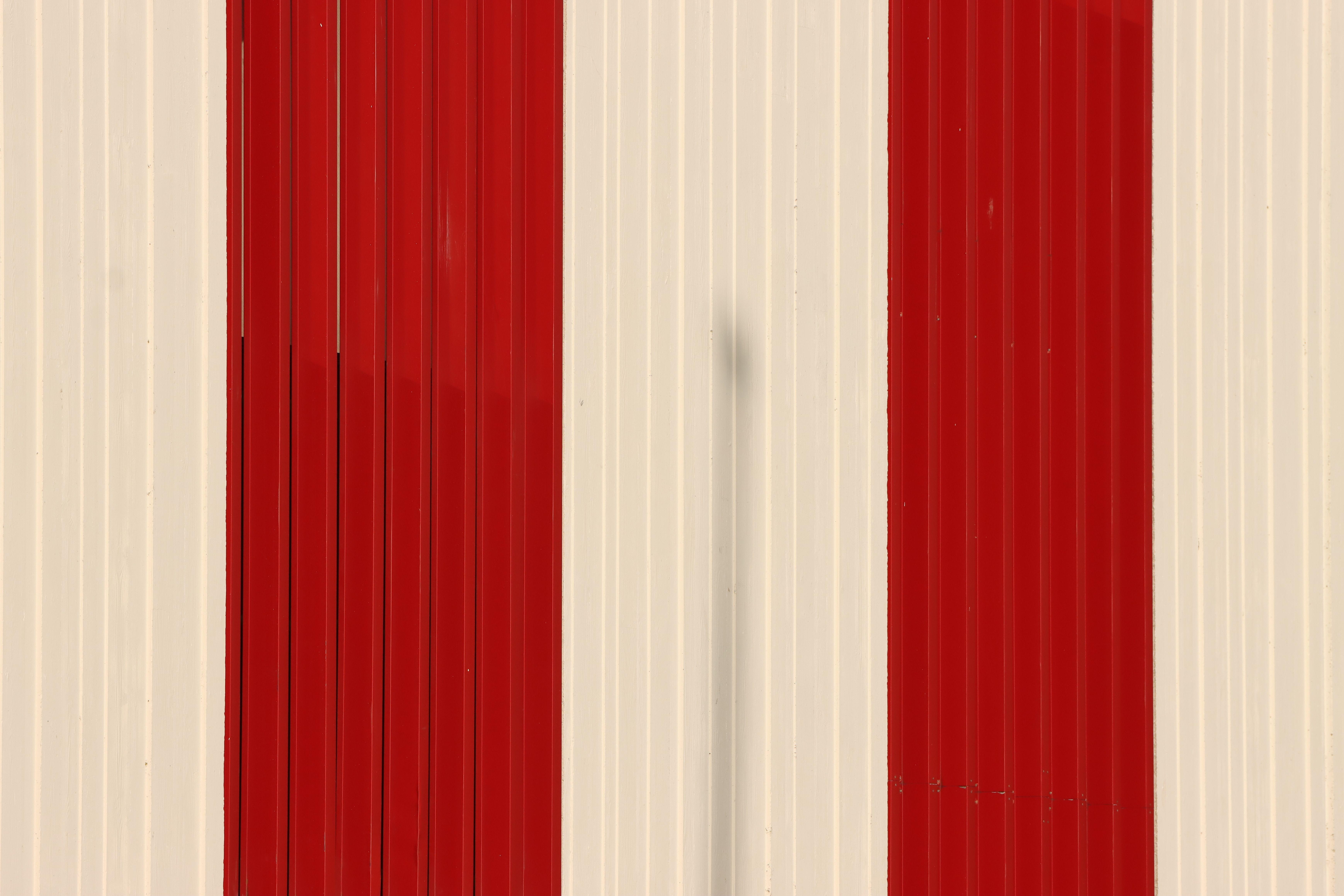 Close-up of a red and white striped wall in Jönköping, Sweden. Modern architectural design.