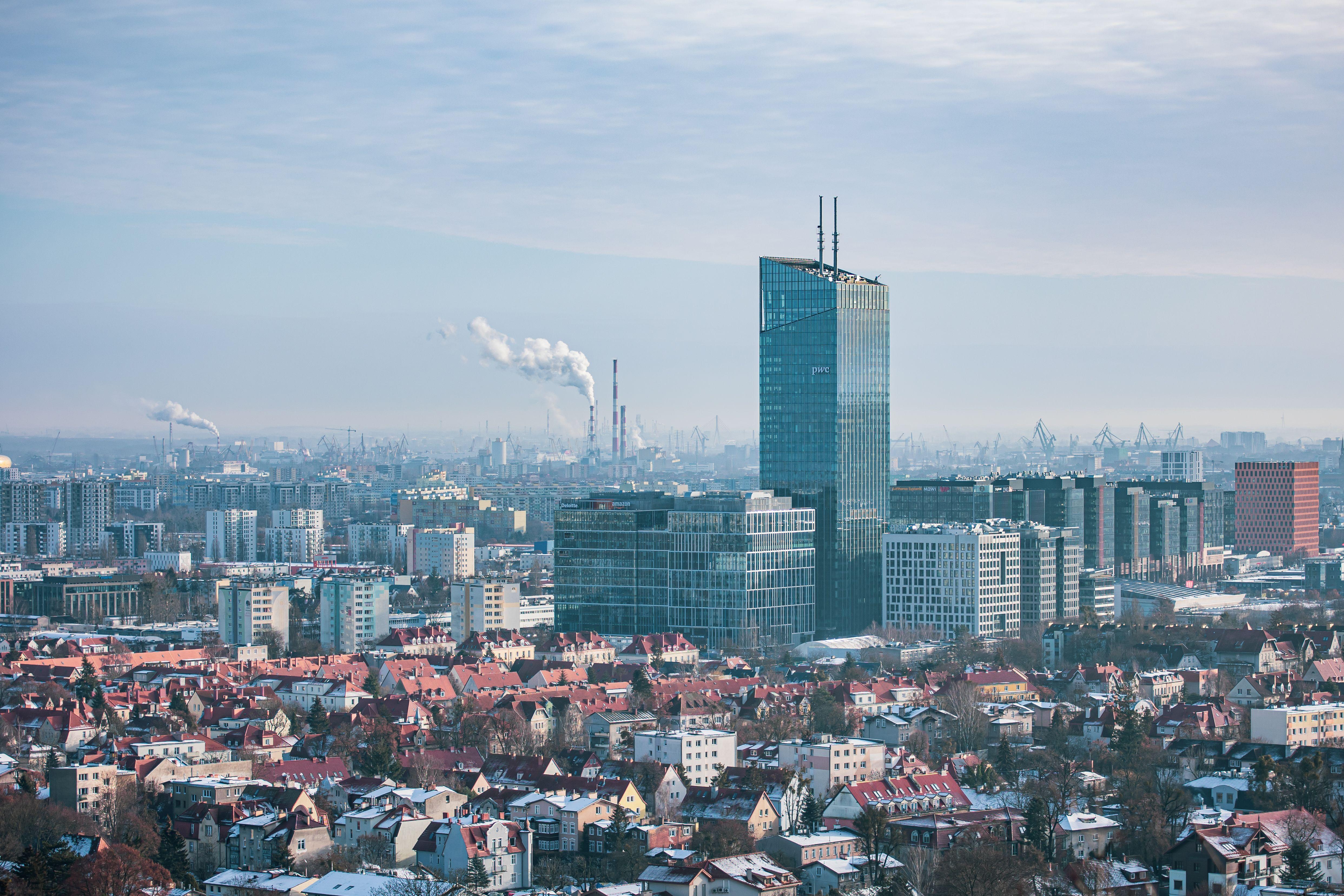 Panoramic aerial cityscape of Gdansk with skyscrapers and rooftops during winter.