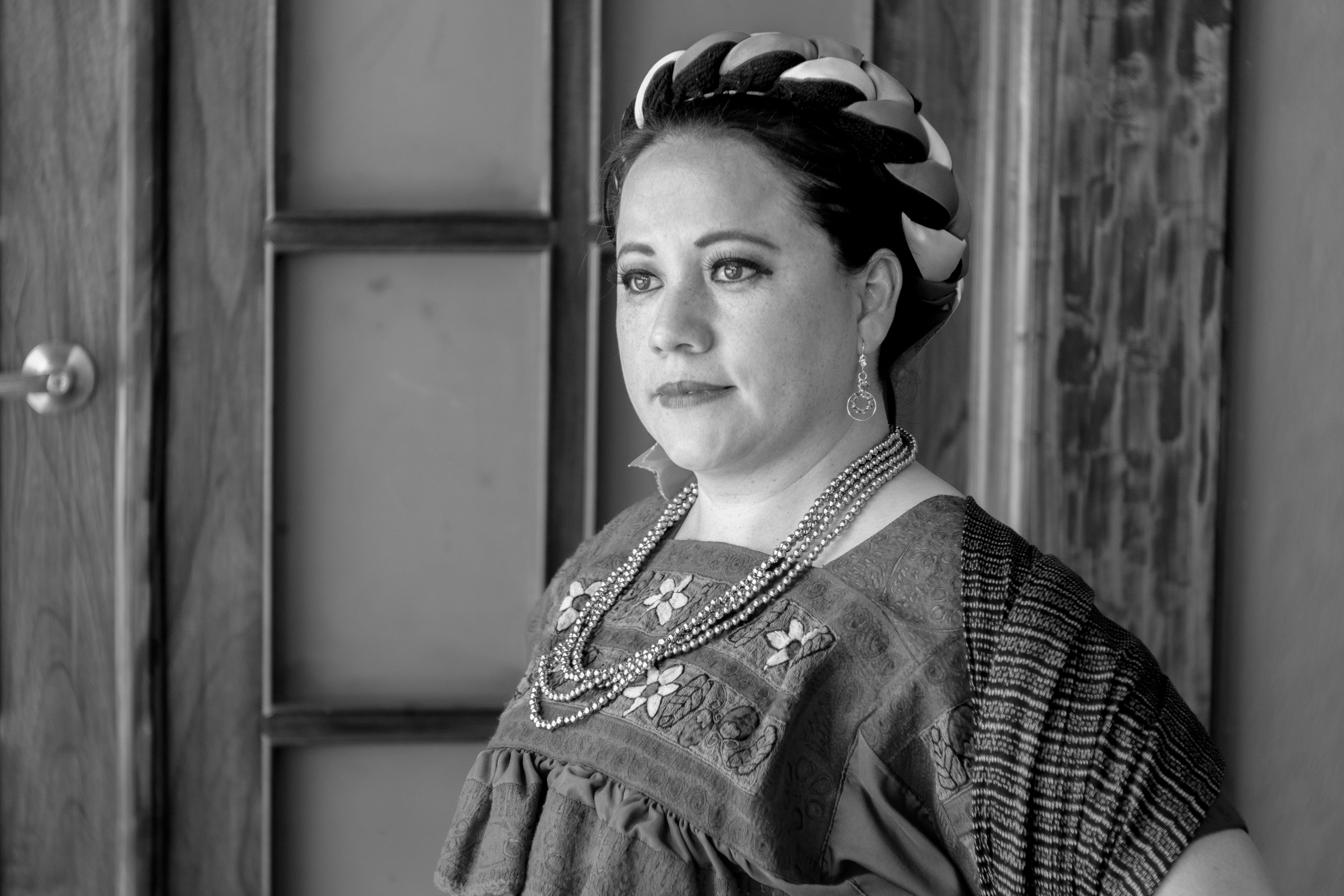 A striking black and white portrait of a woman in traditional Mexican attire, captured in Huauchinango, Mexico.