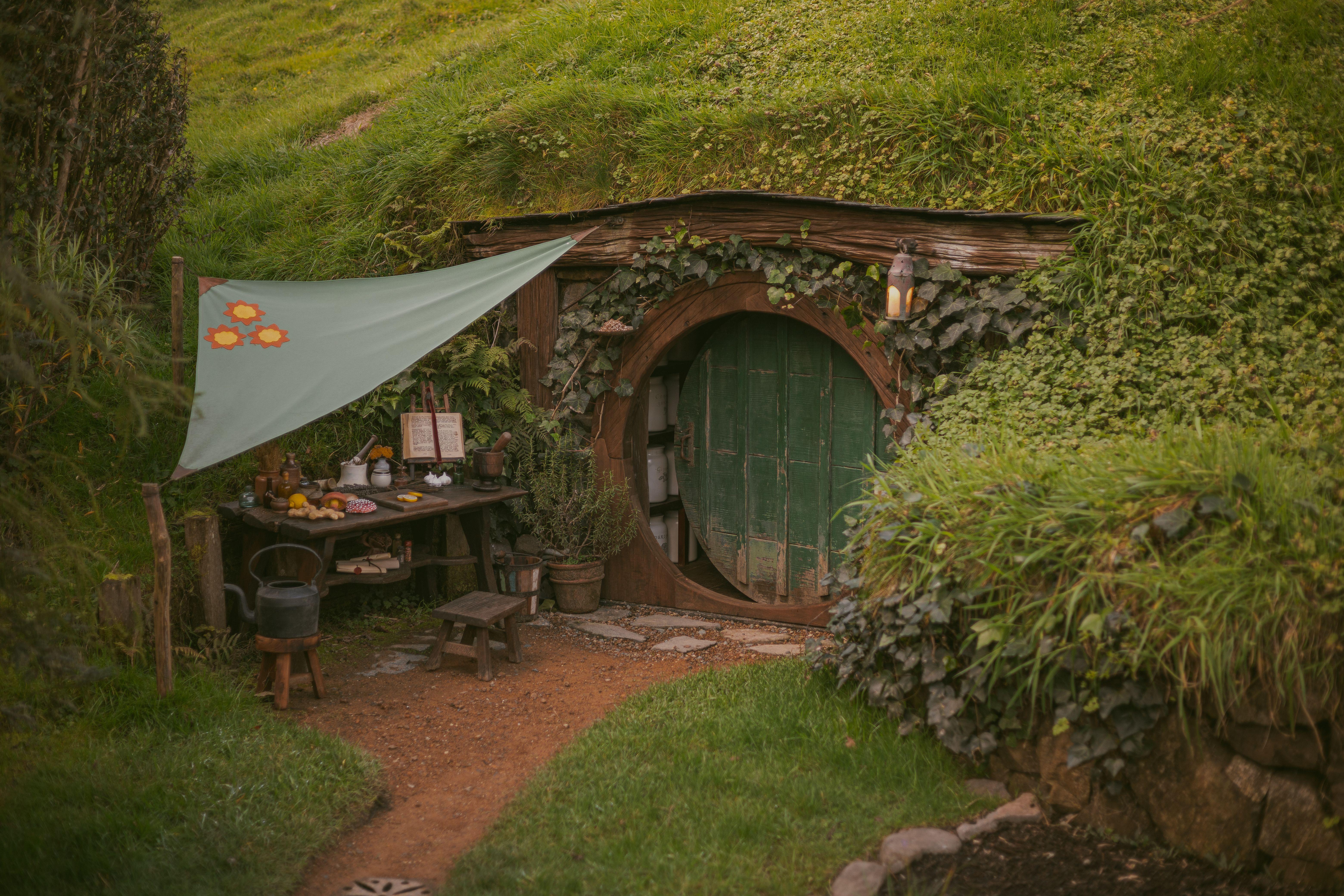 A charming hobbit-inspired house nestled in lush greenery, capturing the essence of rustic countryside living.