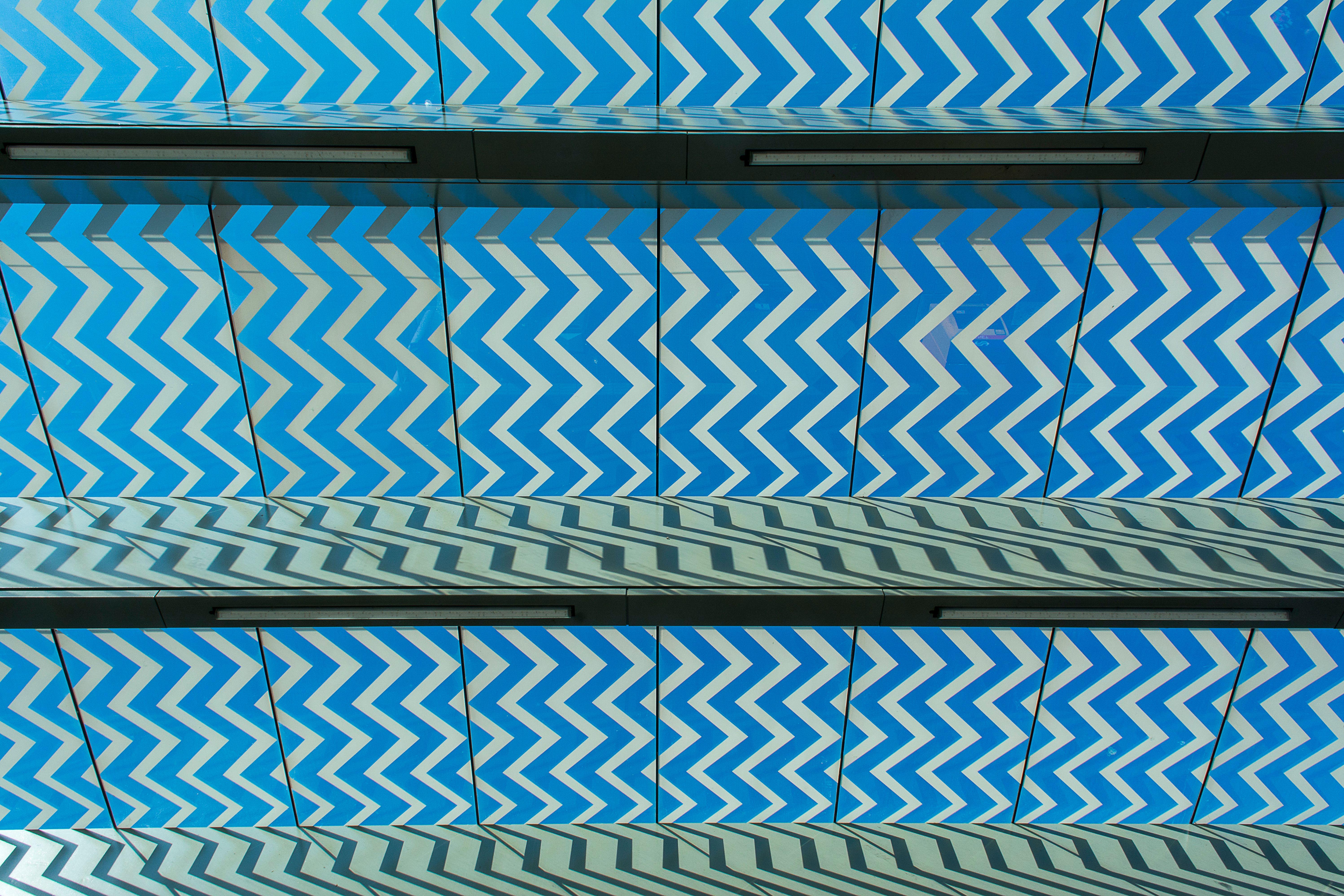 A captivating zigzag pattern in blue on a modern architectural surface, creating a dynamic visual effect.