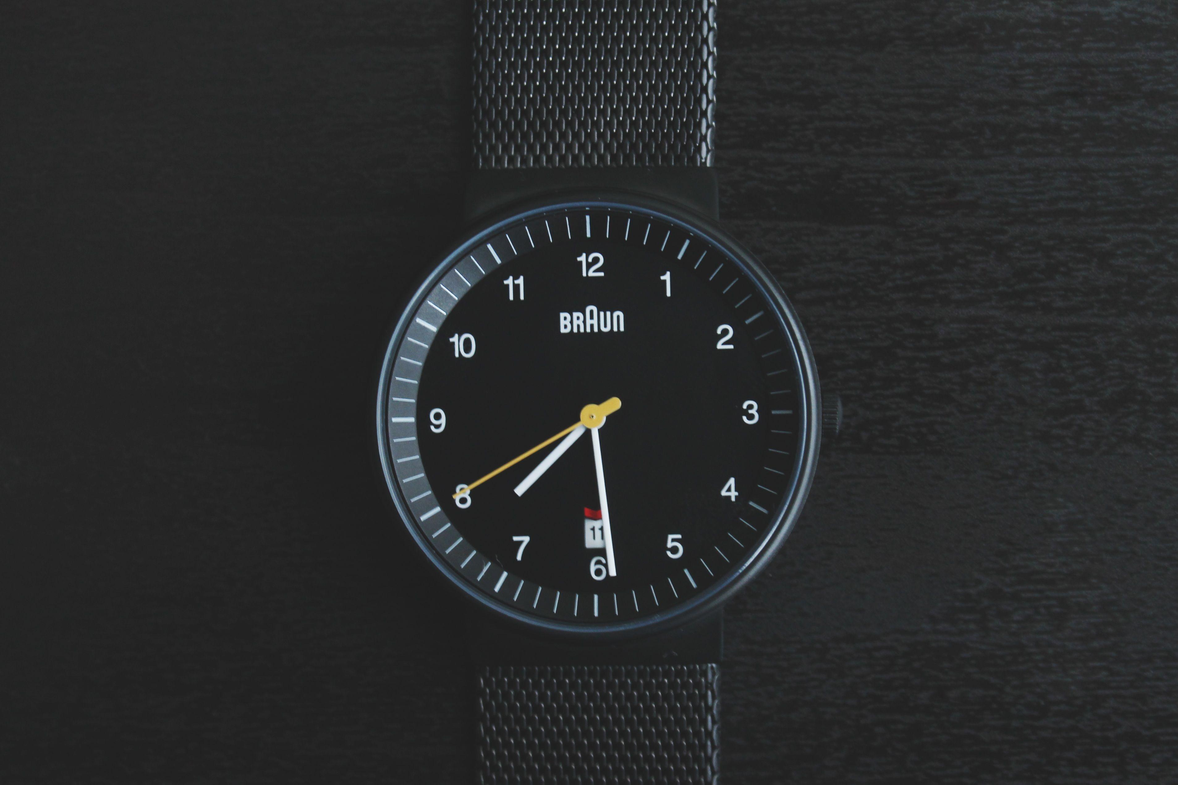 Elegant black wristwatch with a sleek design and precise timekeeping features.