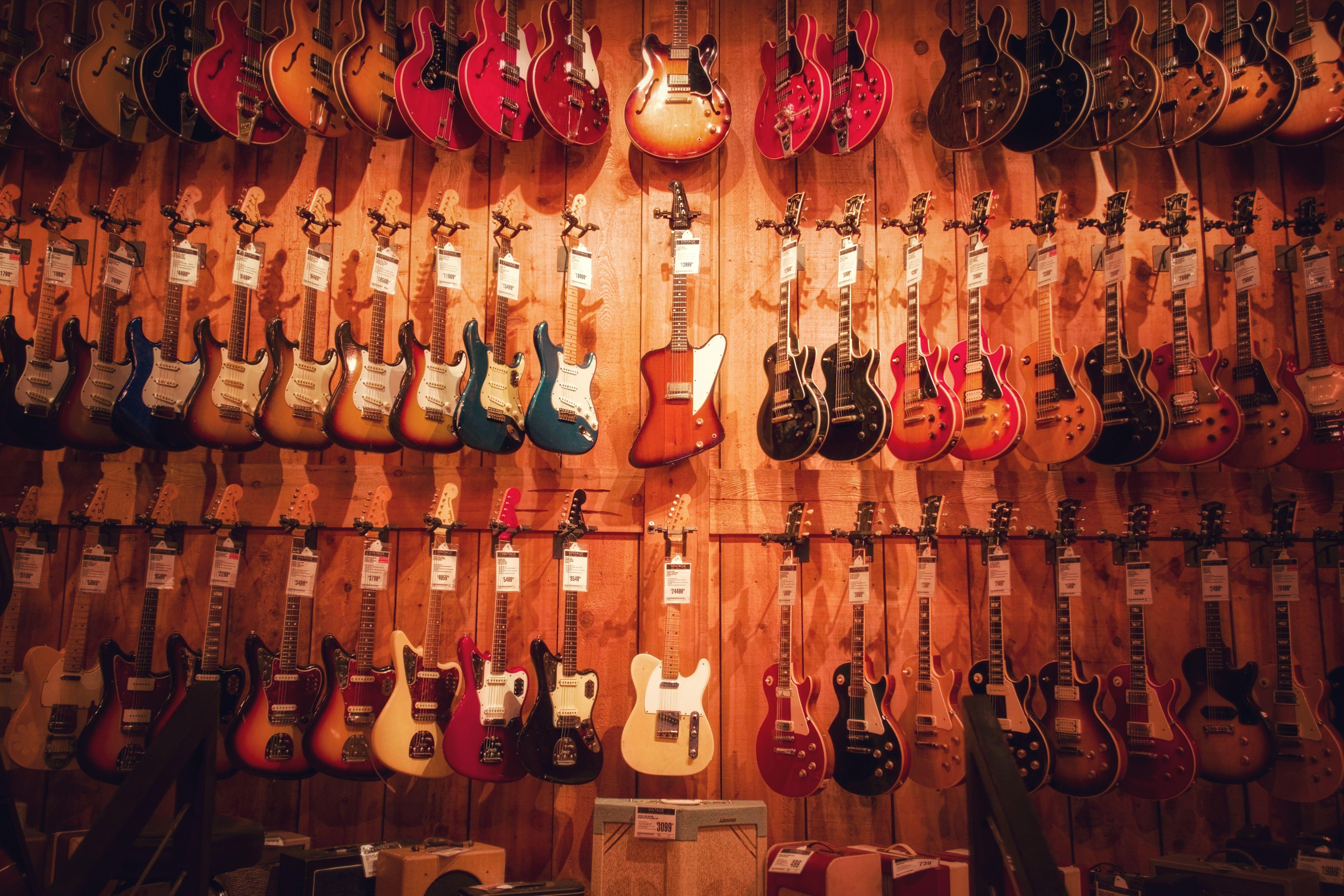 Vibrant display of various electric guitars hanging in a Los Angeles music store.