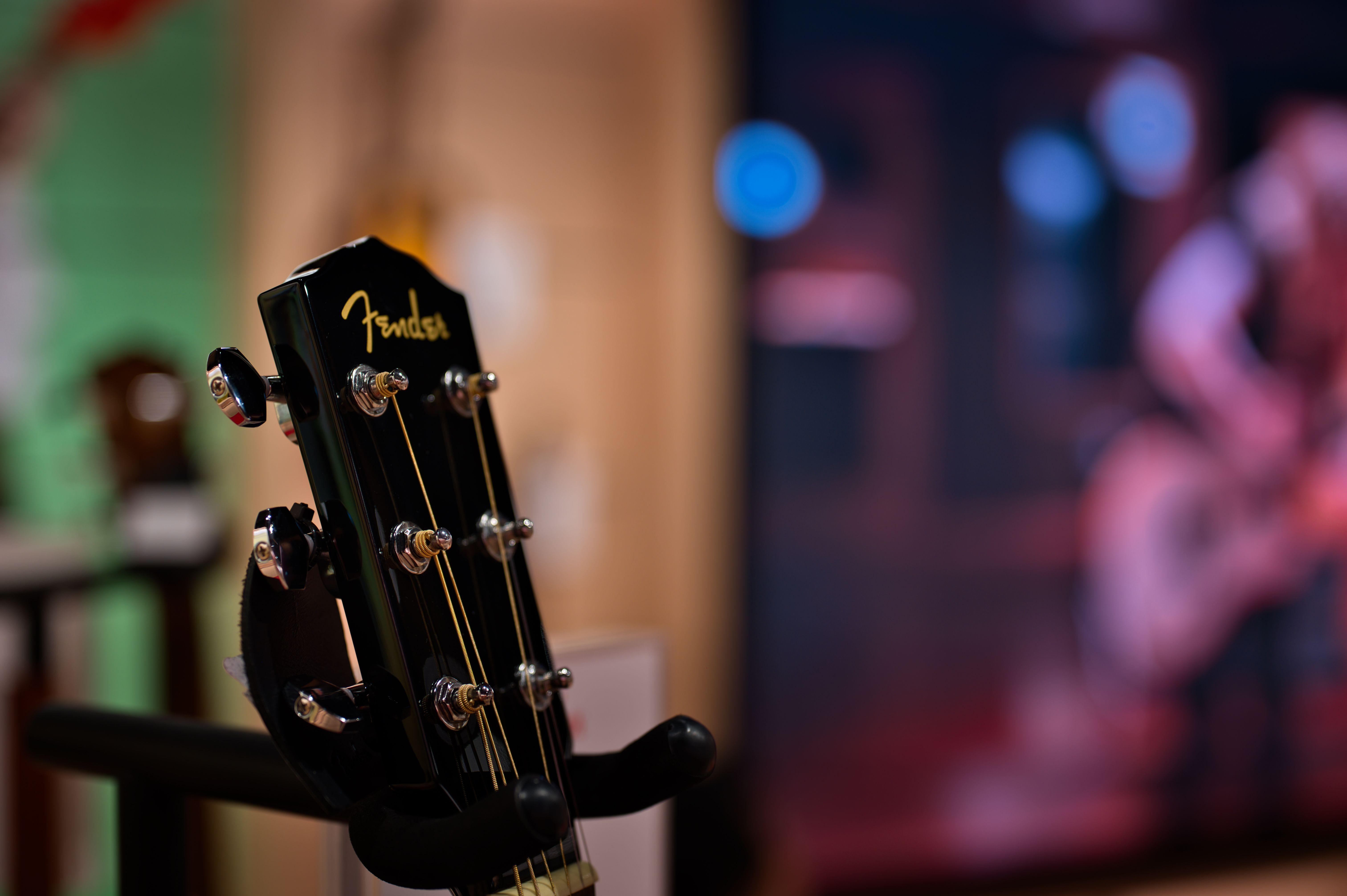 Detailed view of a Fender guitar headstock displayed indoors, Tokyo, Japan.