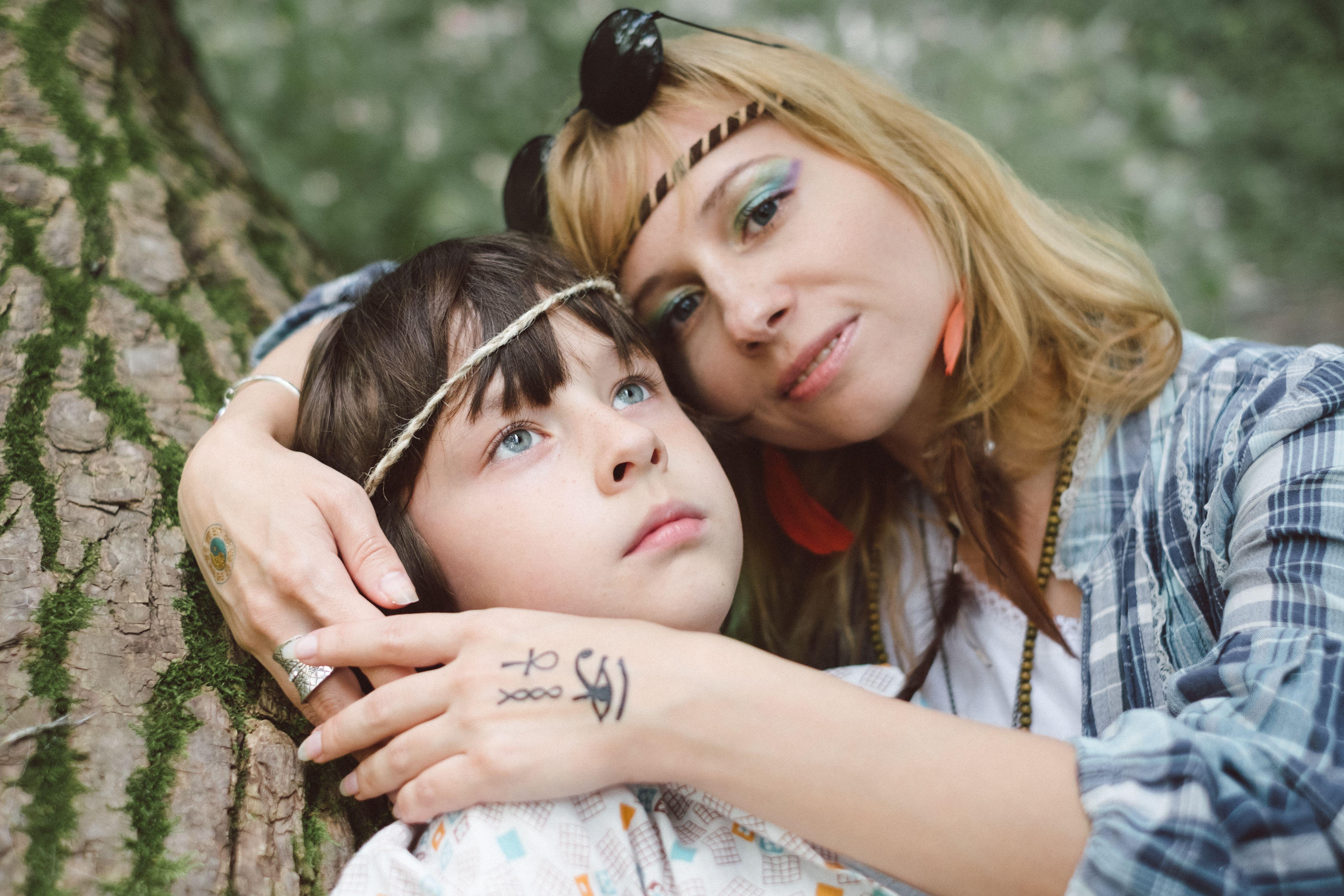 Close-up of a mother and child embracing lovingly outdoors, conveying warmth and connection.