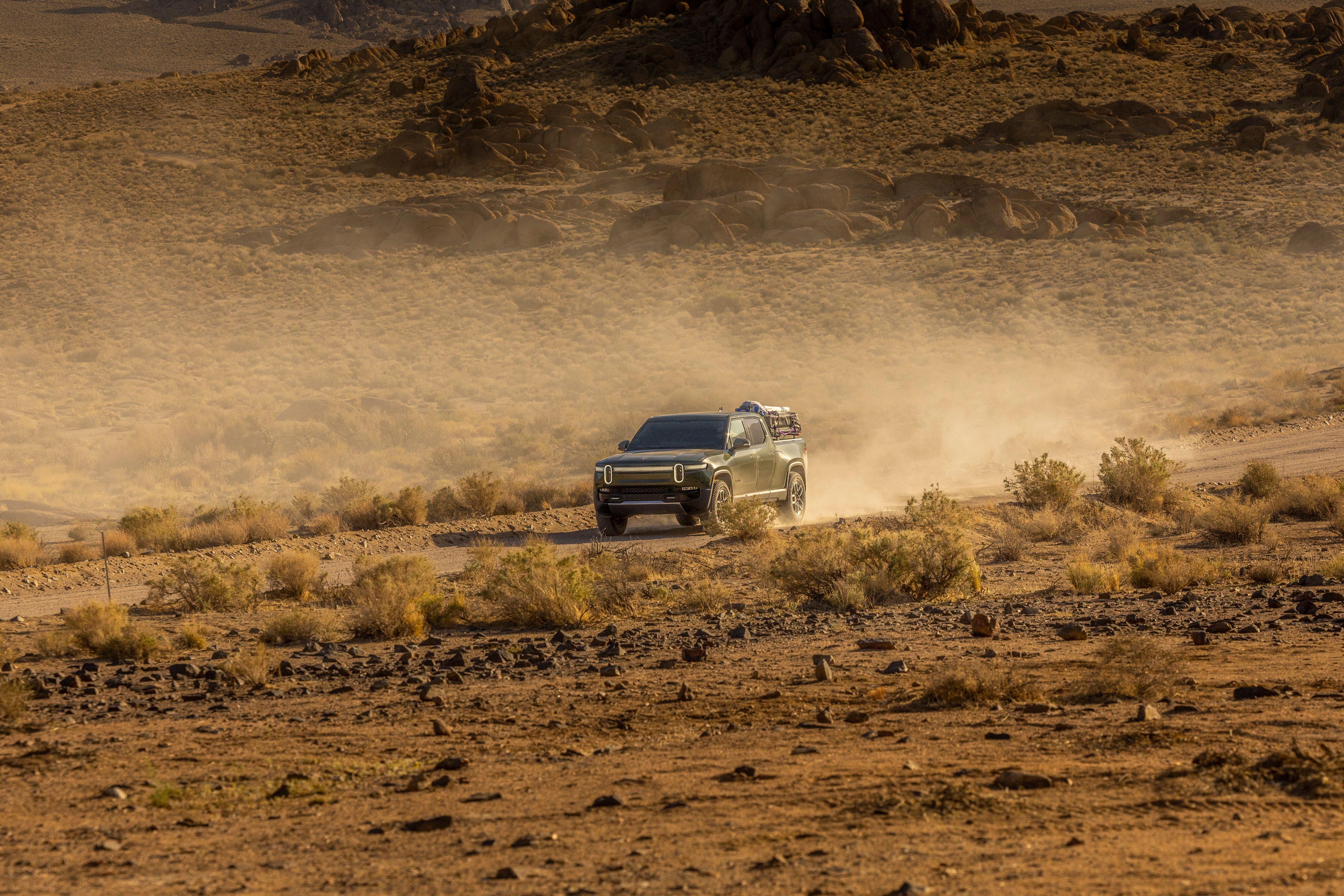 SUV driving through a dusty desert terrain showcasing off-road capabilities and adventure spirit.
