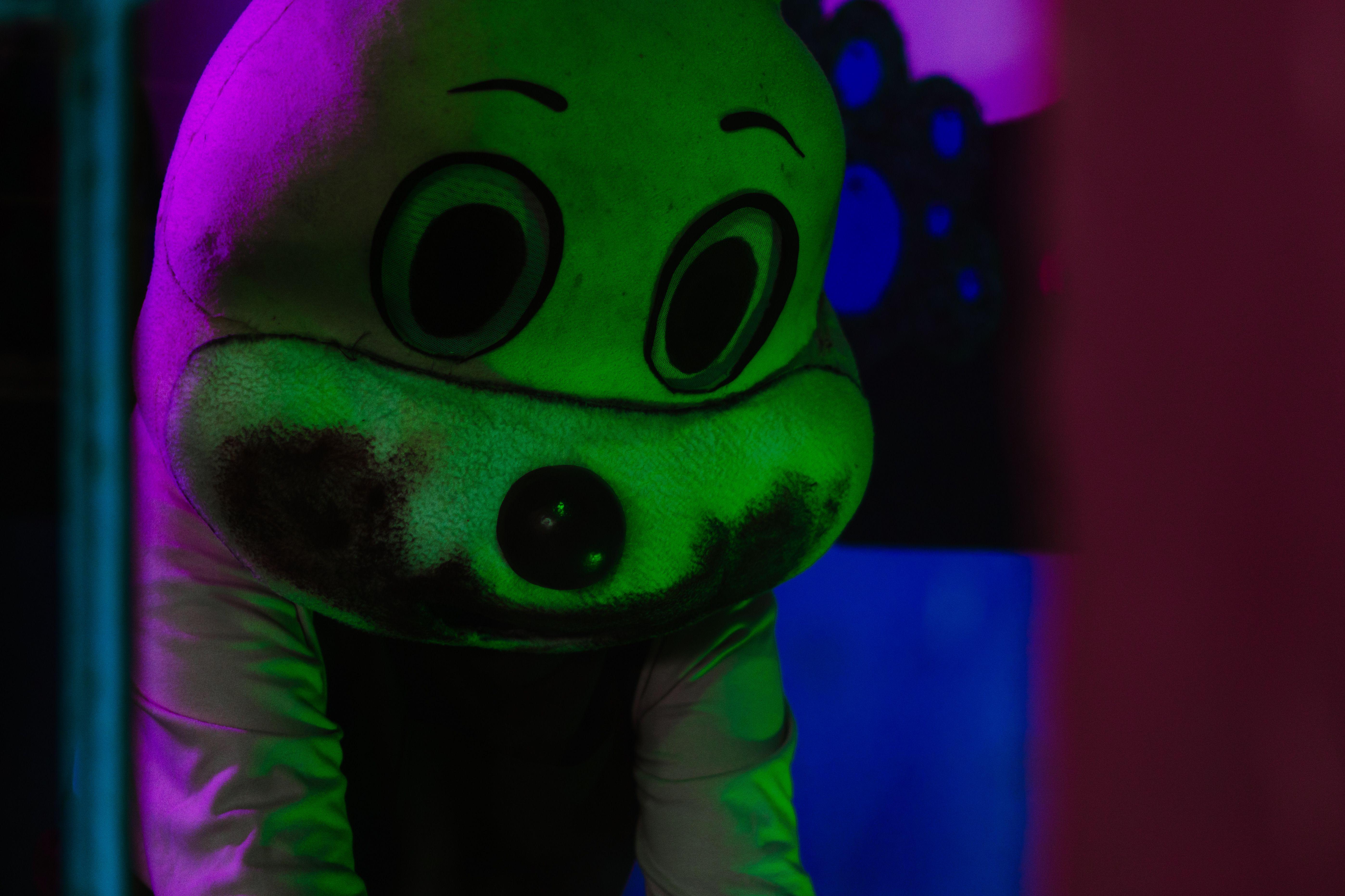A spooky figure in a costume with dramatic lighting, creating a Halloween atmosphere.