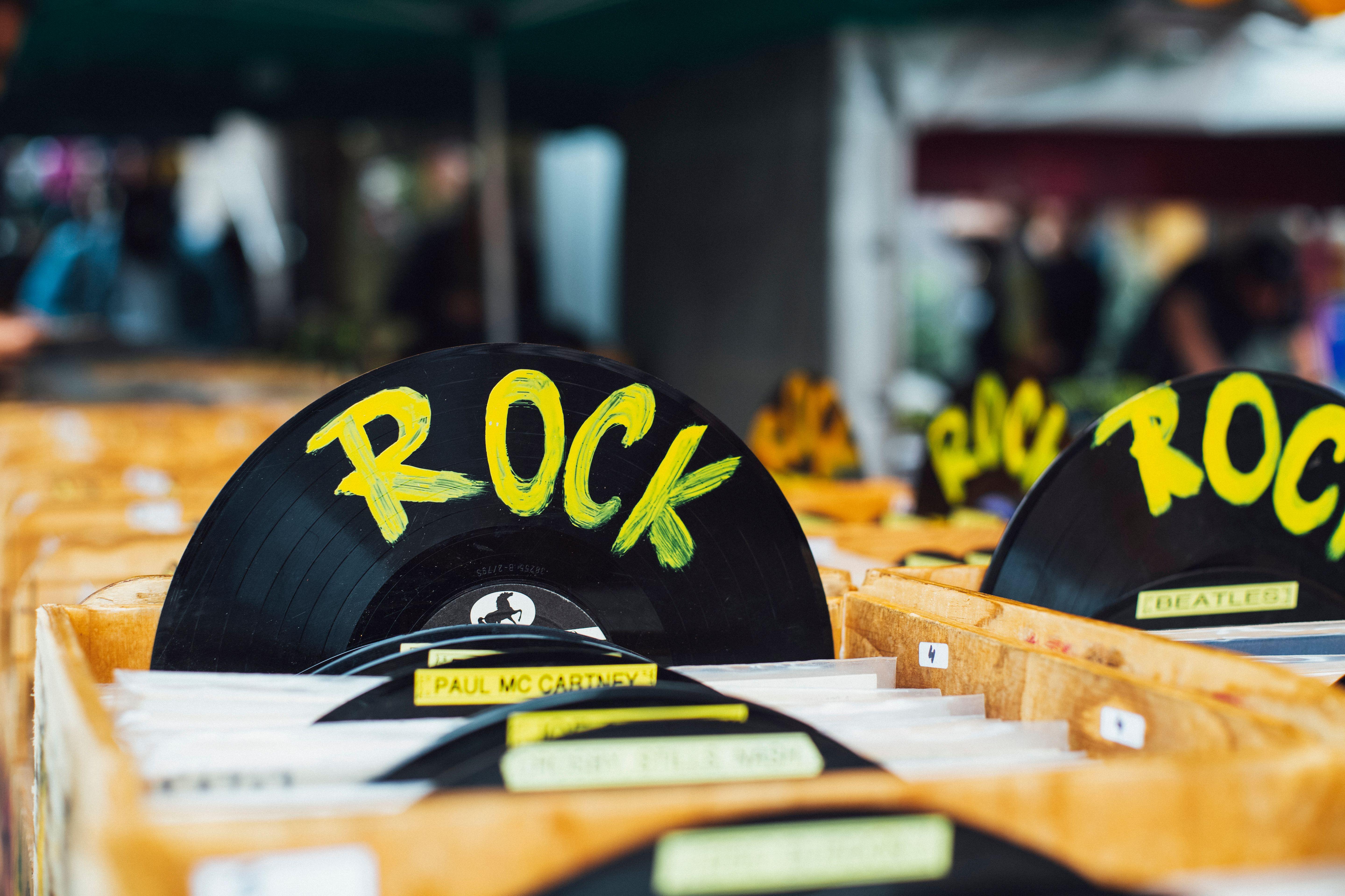 Colorful vinyl records labeled 'Rock' in a vintage music shop, perfect for music enthusiasts.