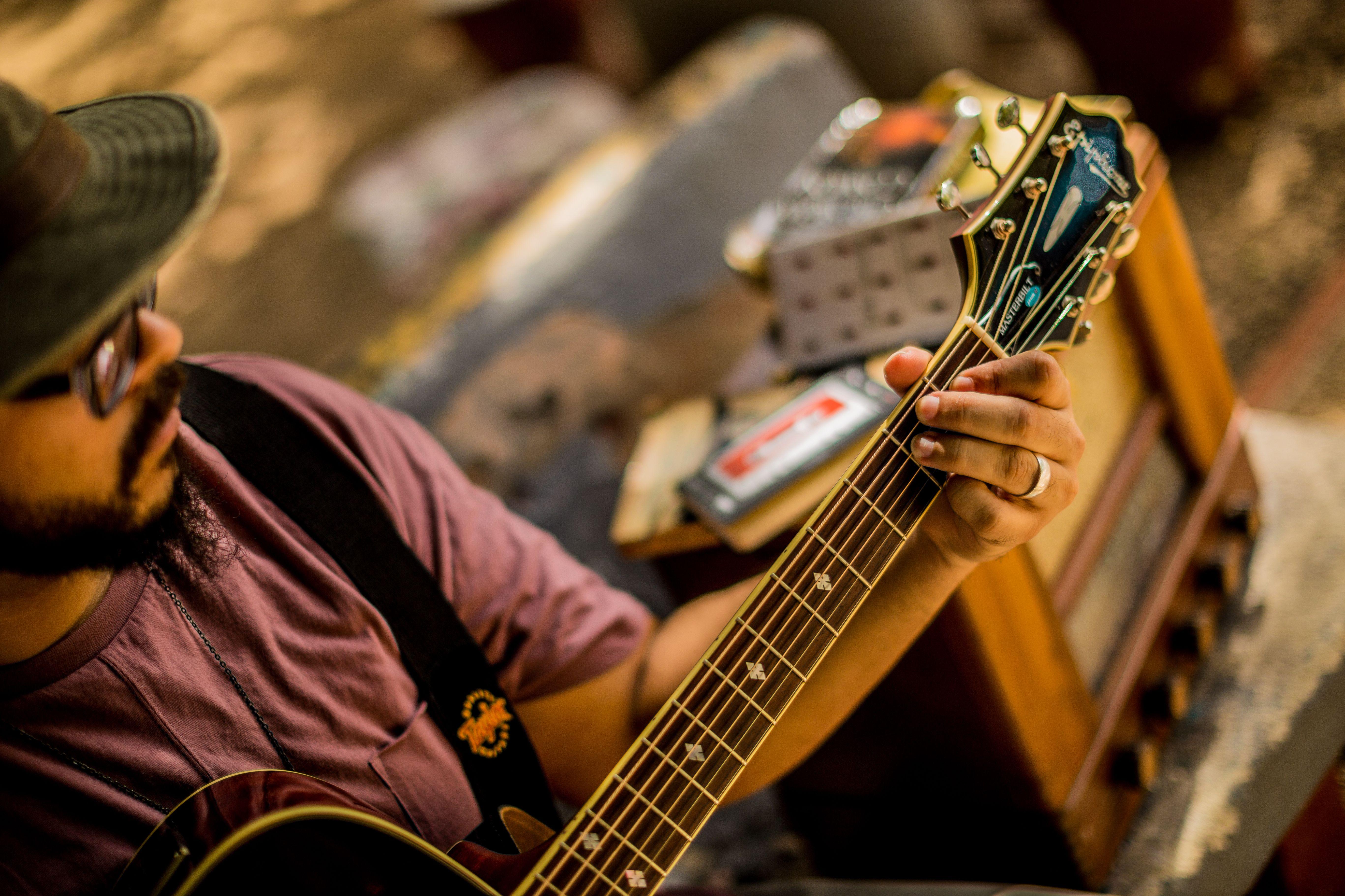A musician playing an acoustic guitar outdoors, creating a relaxed atmosphere in San Juan.
