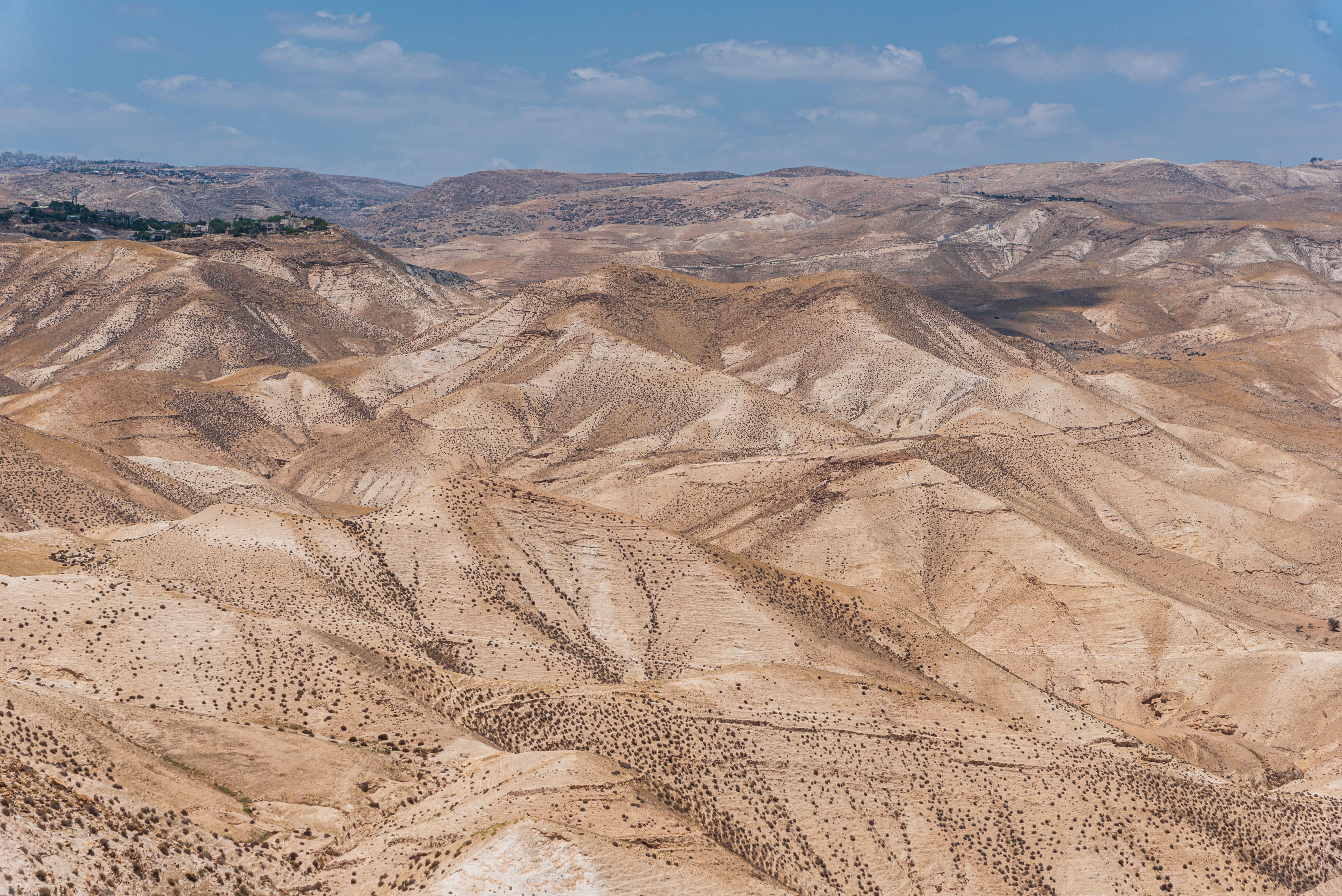 Scenic view of arid desert hills under a clear blue sky in Israel.