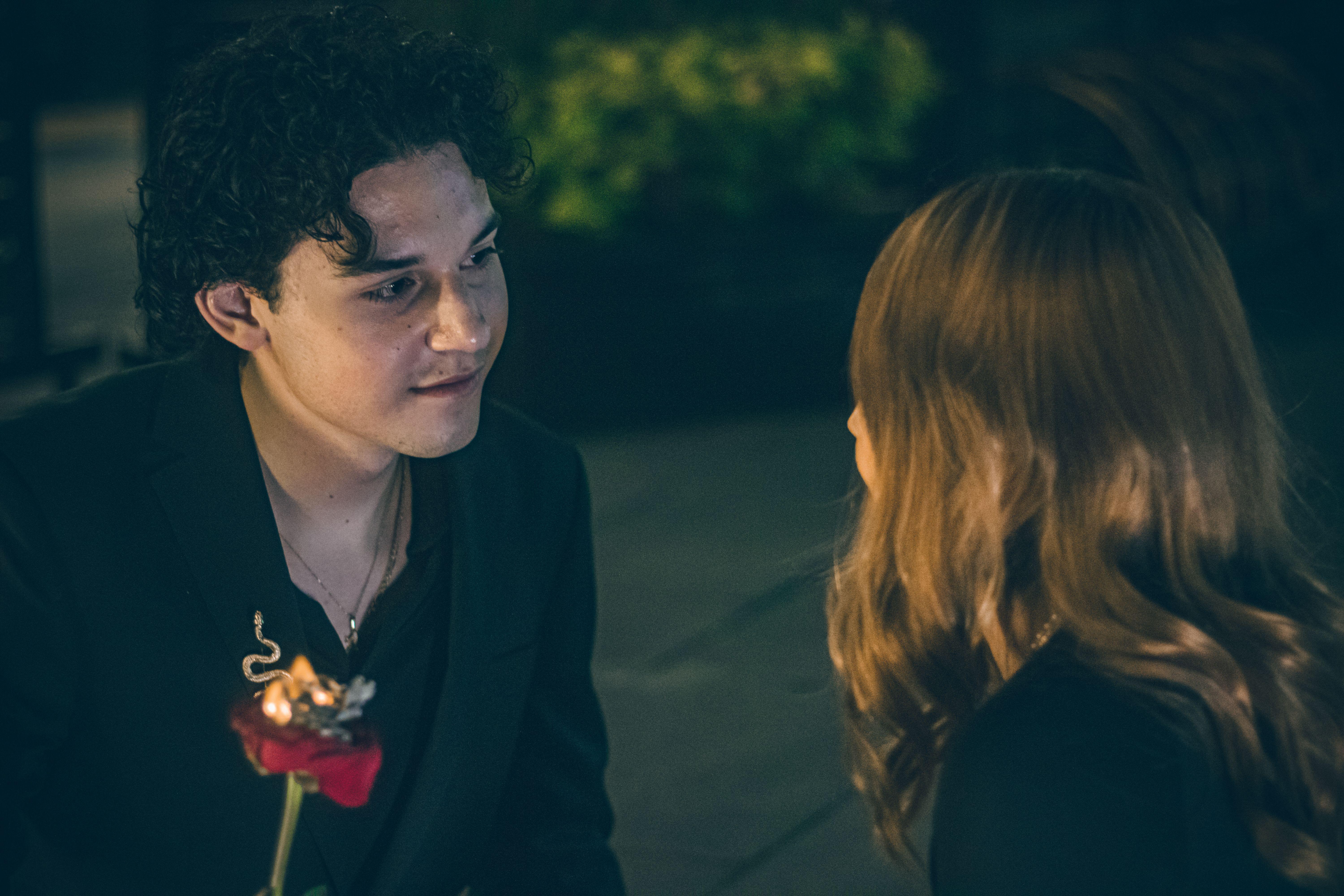 A couple shares a tender moment outdoors at night in Mexico City.