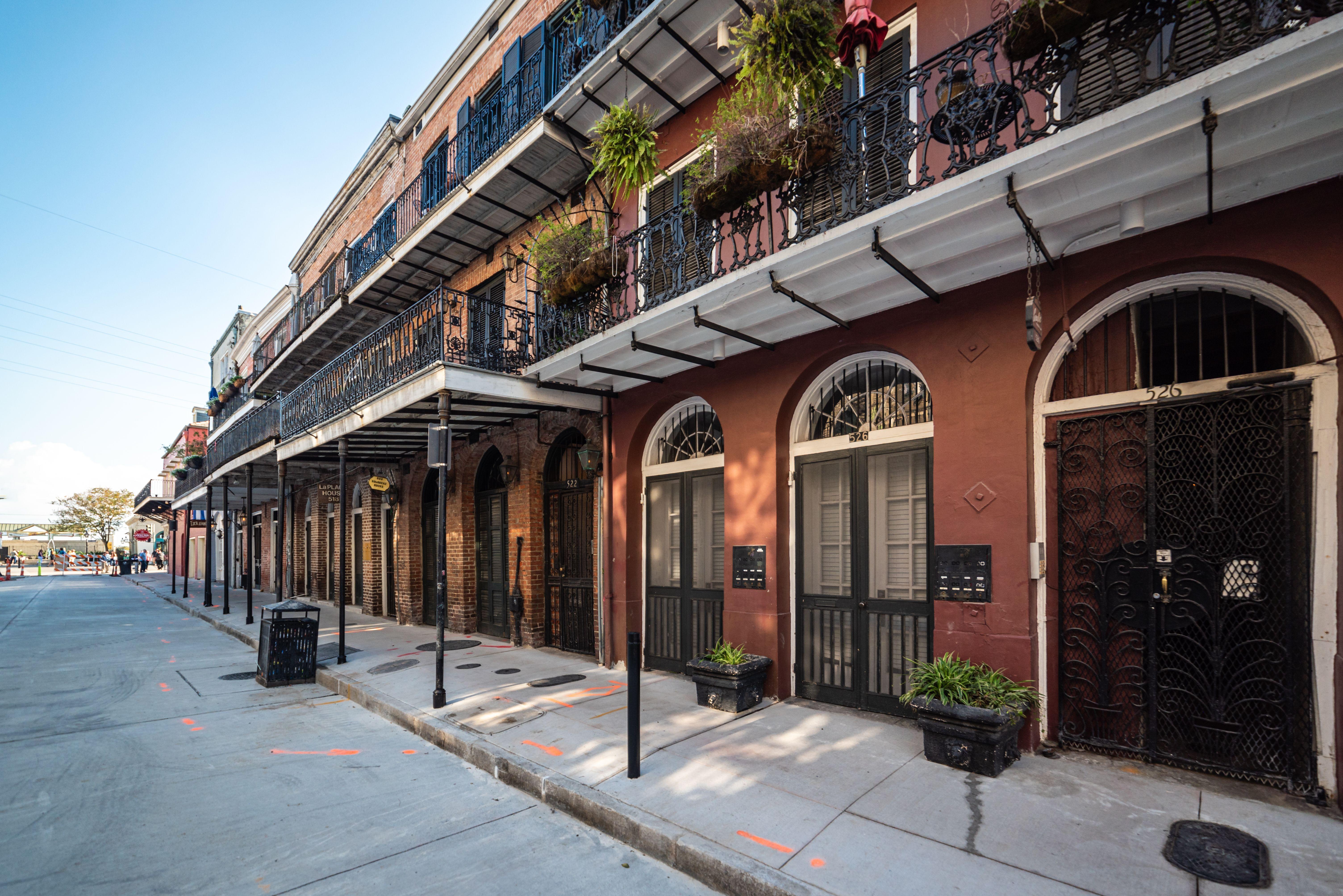 Iconic ironwork balconies of a historic New Orleans street in the French Quarter.