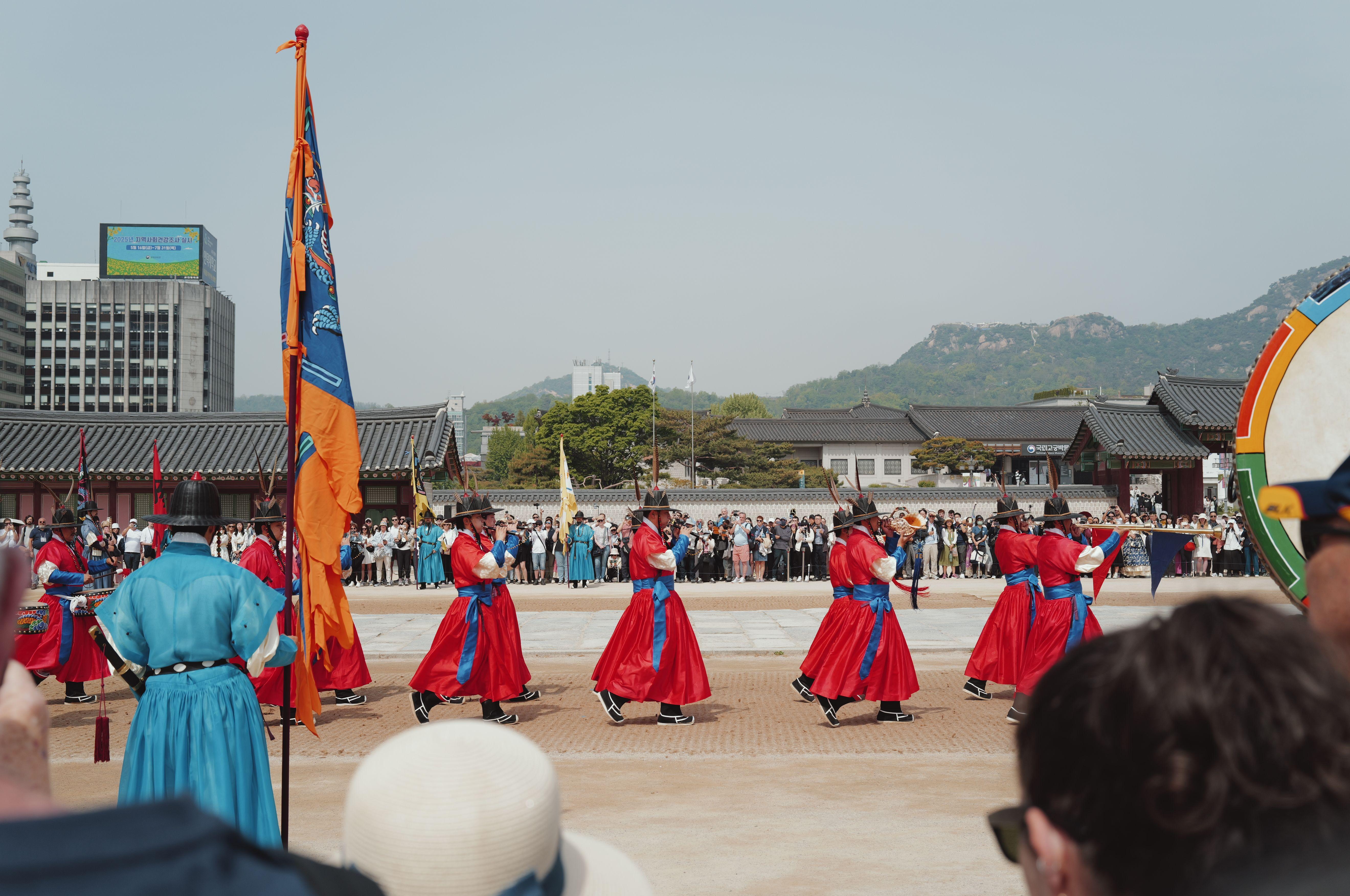 Vibrant traditional guard ceremony at a palace in Seoul, South Korea, showcasing cultural heritage.