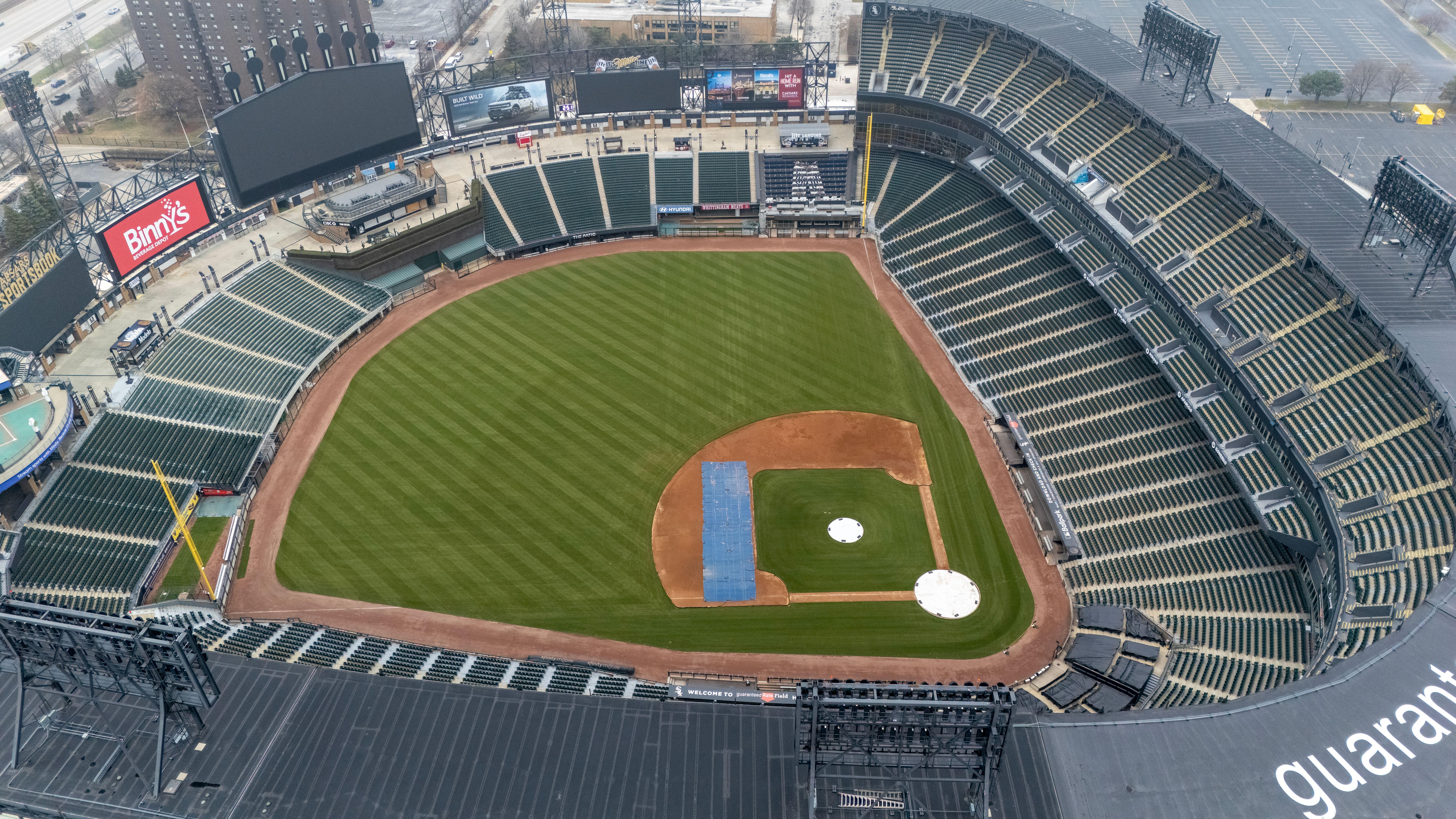 Empty Guaranteed Rate Field in Chicago captured from above, showcasing the lush green baseball field and seating areas.