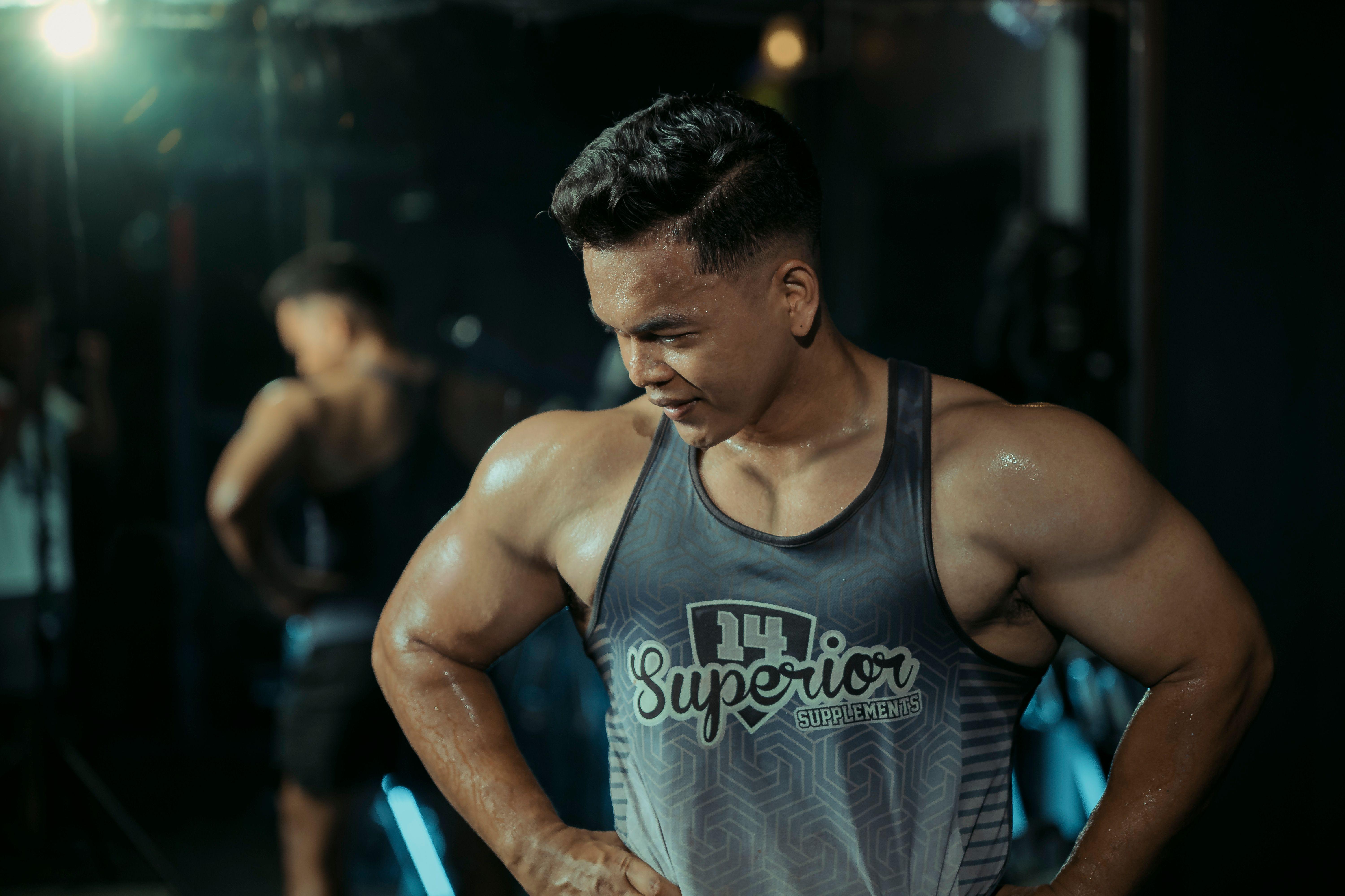 Muscular man in gym showing strength and determination.