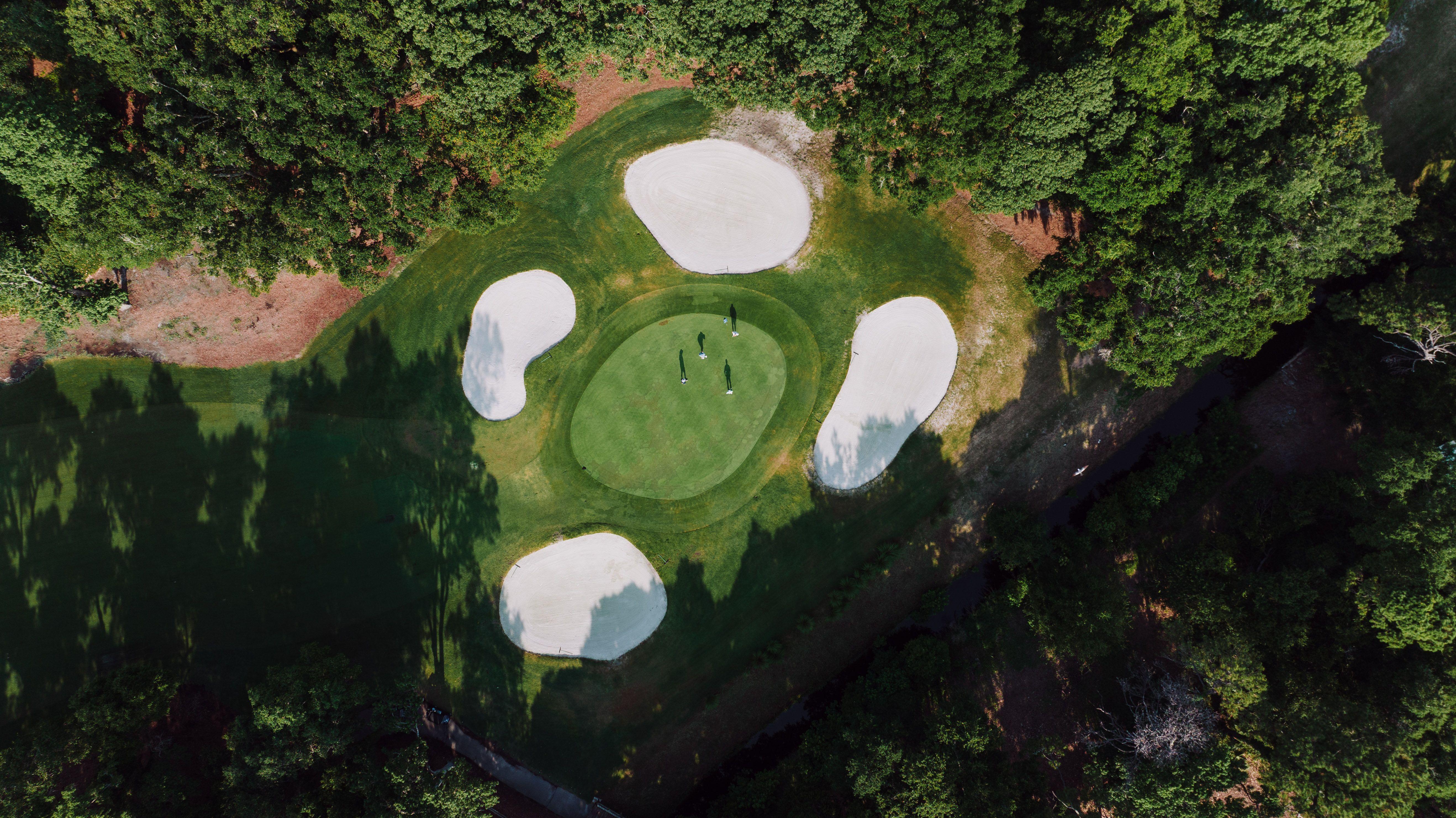 Stunning aerial shot of a lush golf course on Hilton Head Island, showcasing pristine fairways and bunkers.