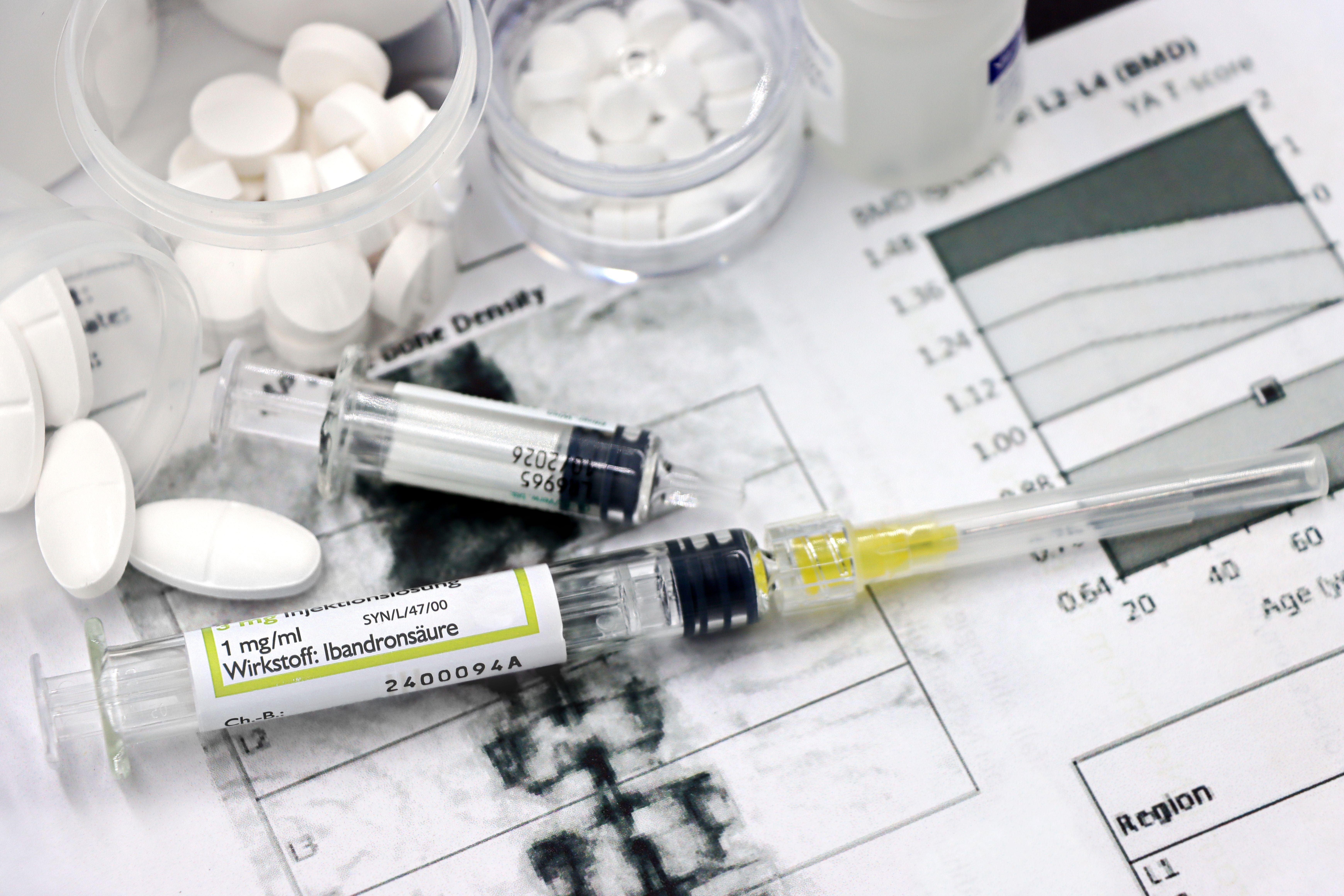 Medical arrangement of osteoporosis treatment tools with injections and pills.