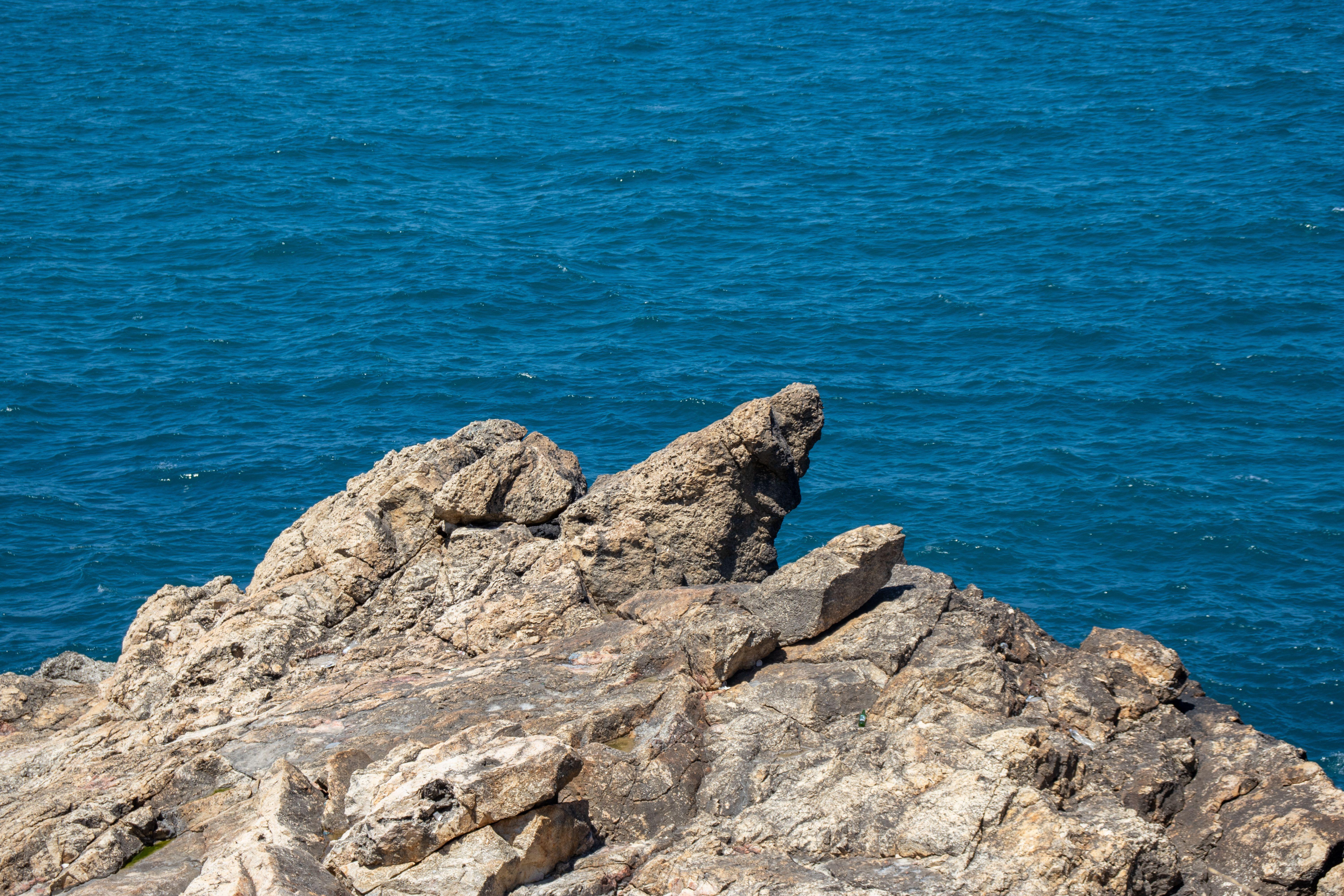 A tranquil view of a rocky coastline with blue Mediterranean Sea in Istanbul, Turkey.