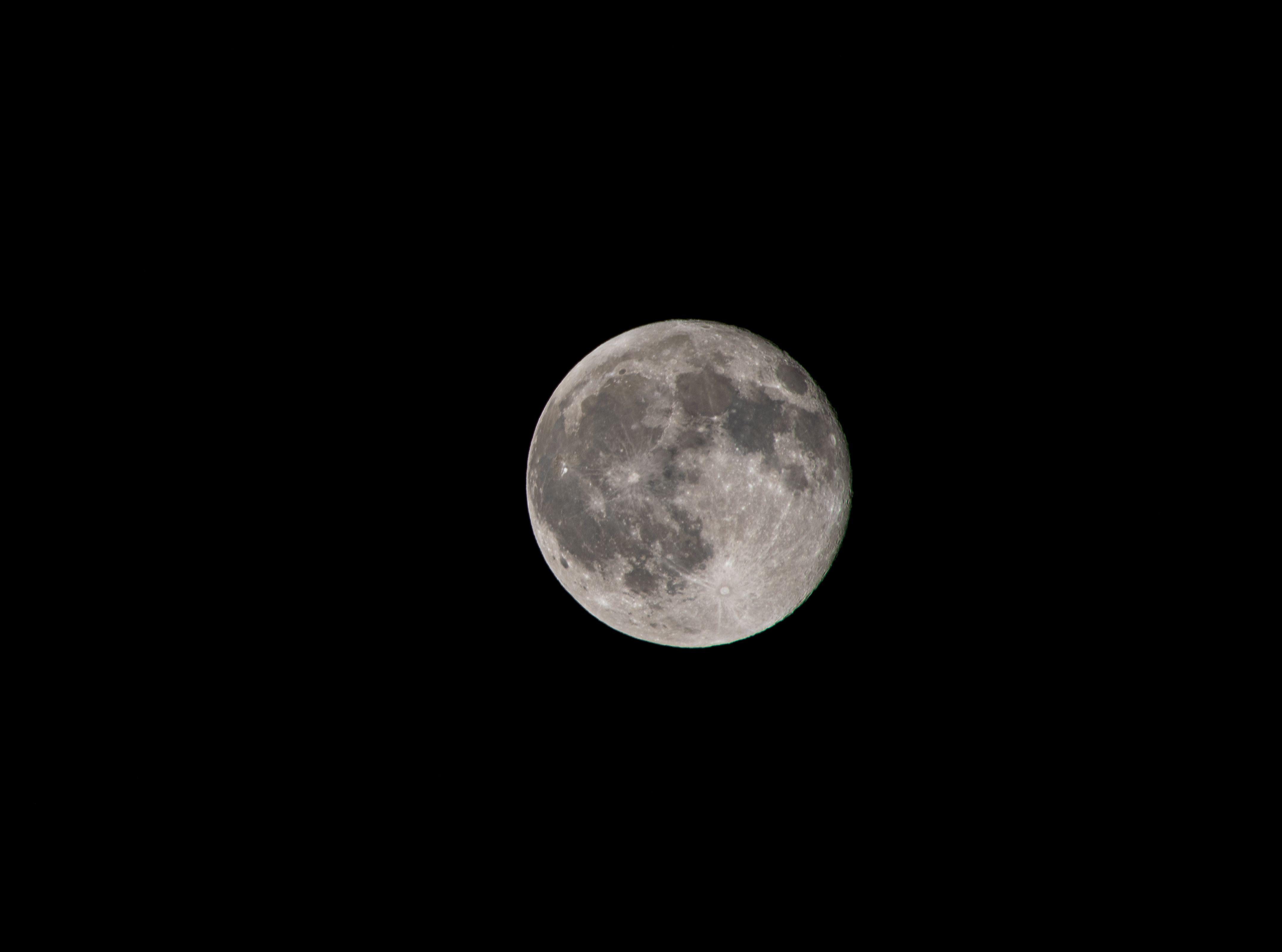 A high-resolution image of the full moon against a black night sky, showcasing lunar details.