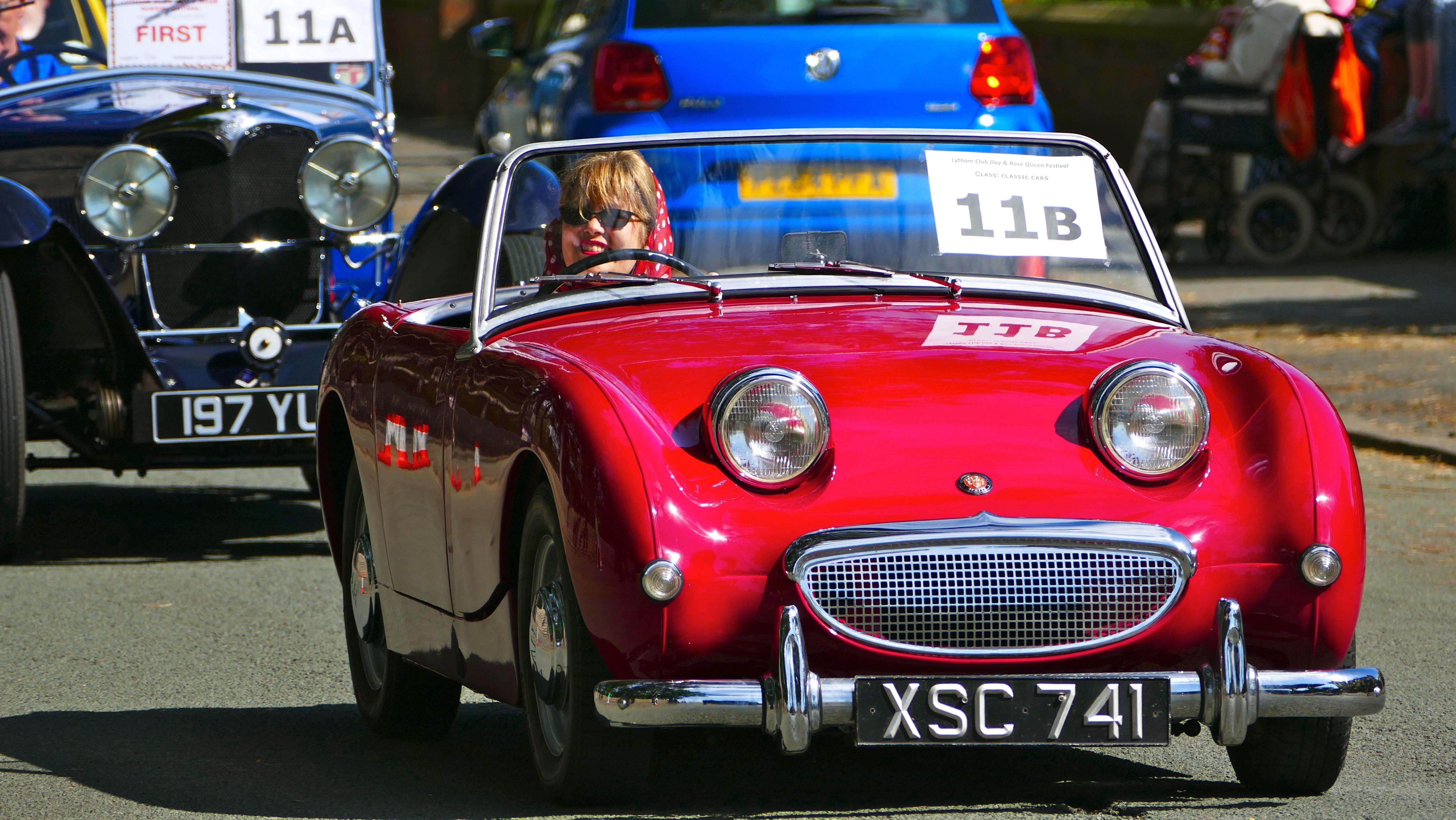 Vintage red Austin Healey on display at a car show in Lytham St Annes, England. Bright sunny day.
