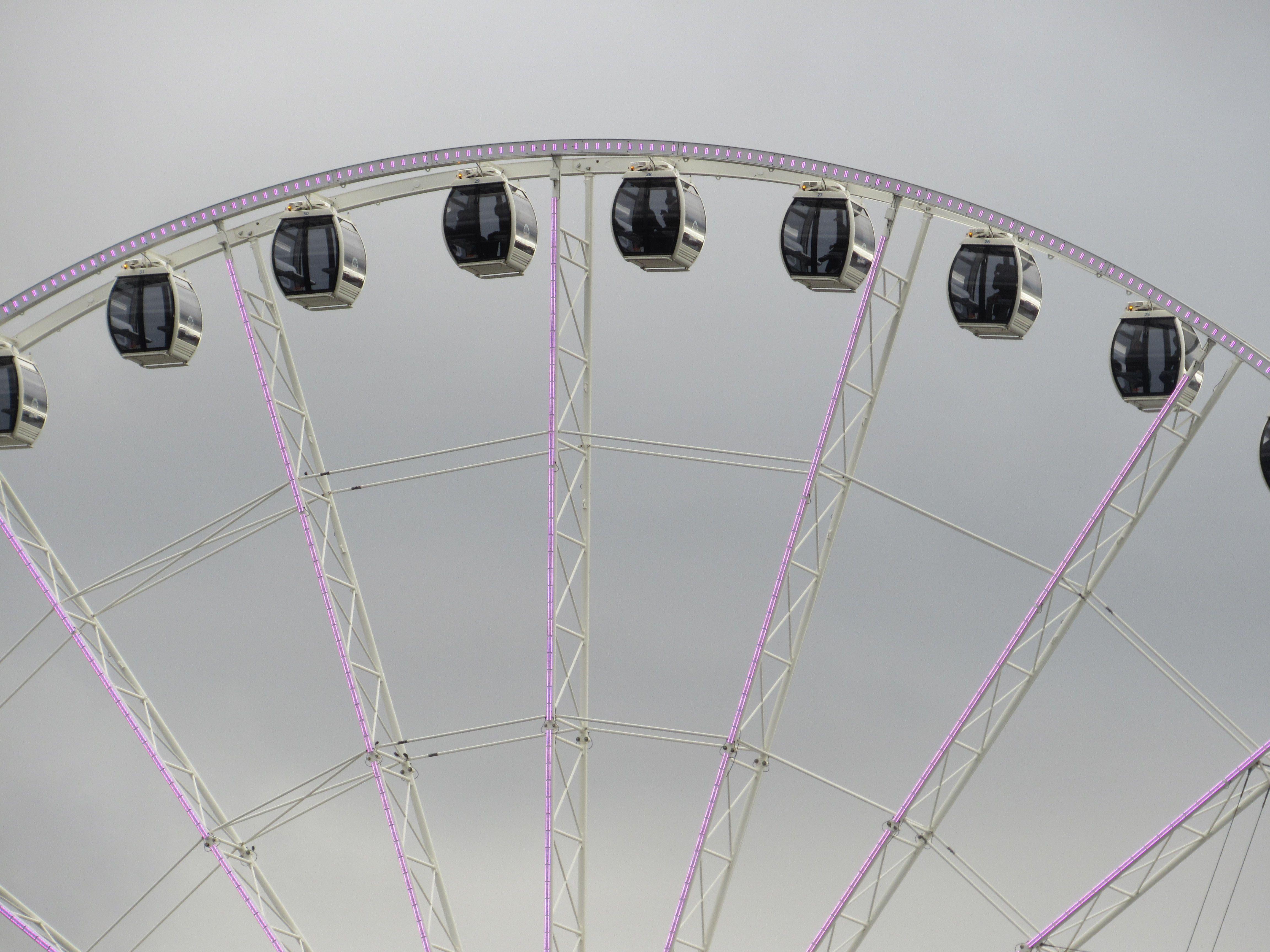 Close-up view of the Seattle Great Wheel's gondolas on a cloudy day.