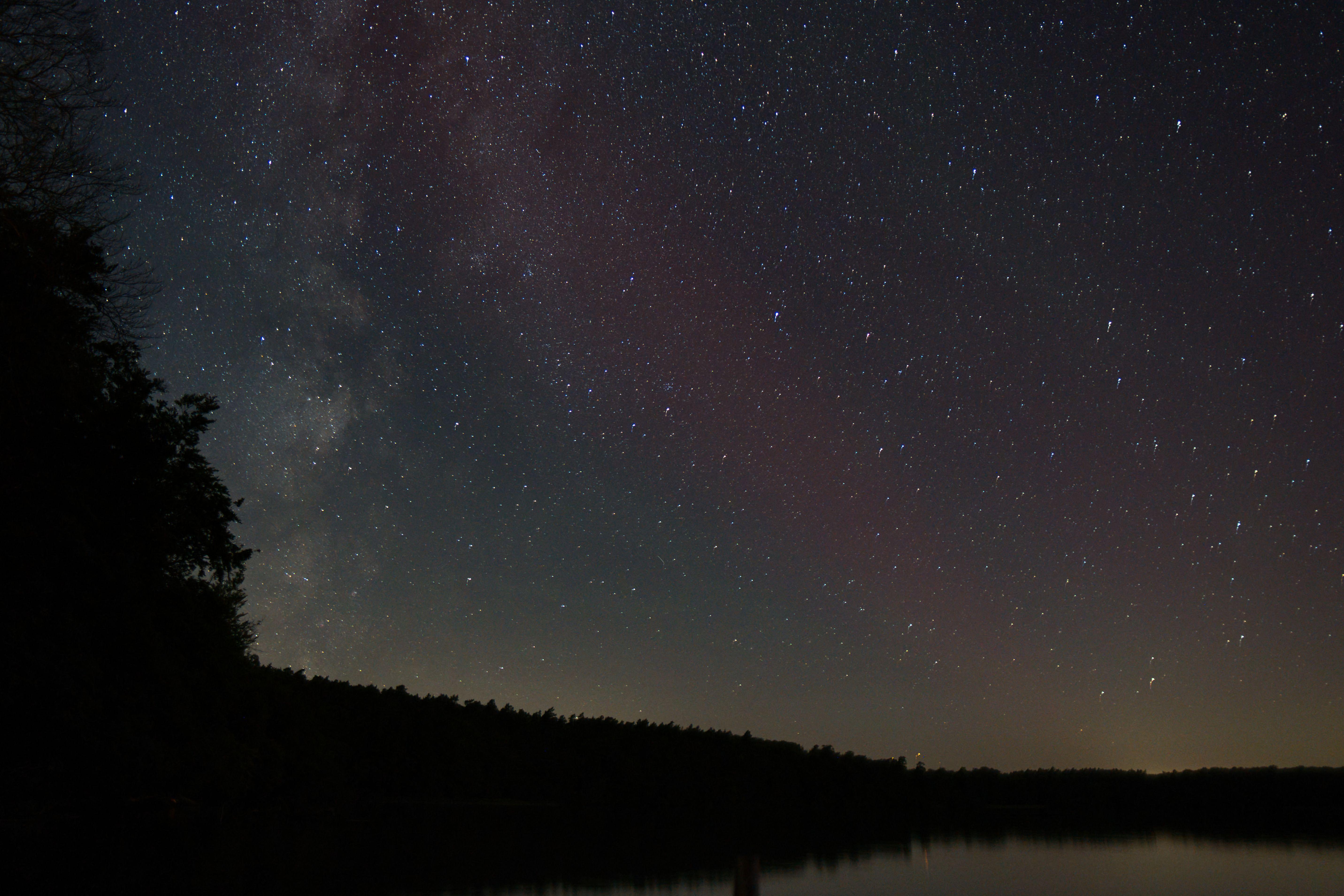 Stunning view of the Milky Way over Stechlin Lake in Brandenburg, Germany, showcasing a clear starry night sky.