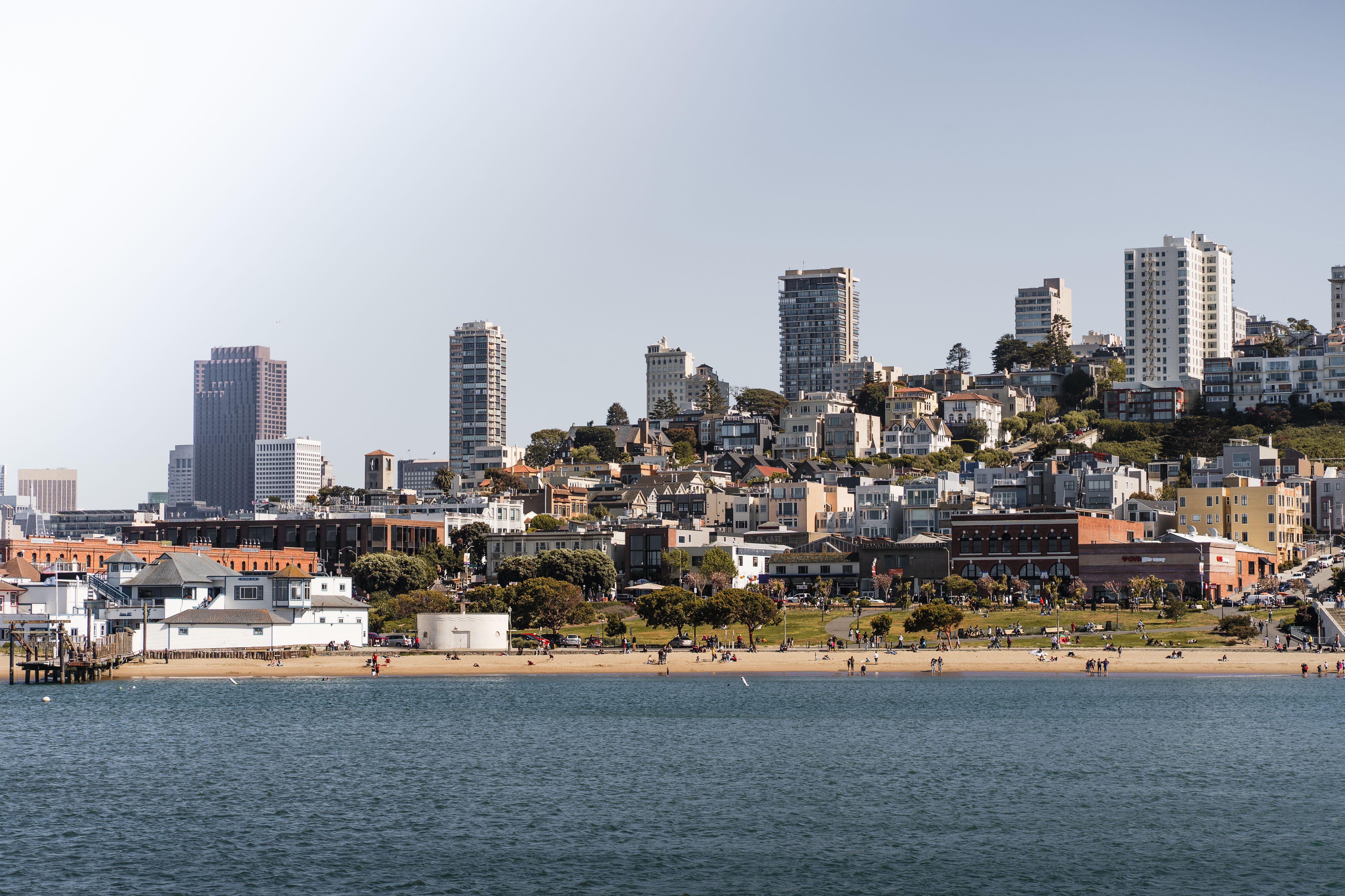 A scenic view of San Francisco's coastal skyline with beachfront and urban landscape.