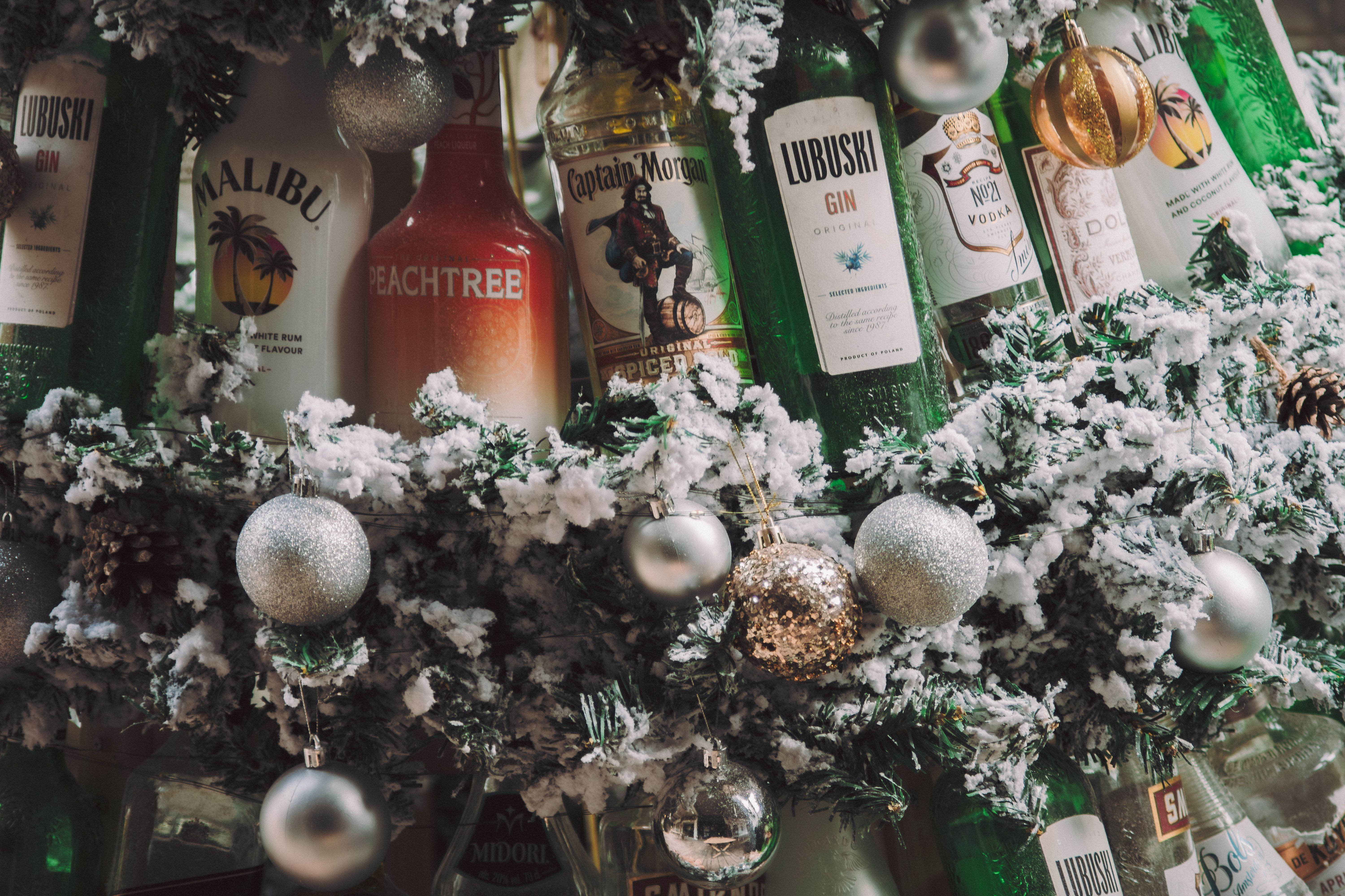 Holiday-themed display with various bottles and festive ornaments, perfect for winter celebrations.