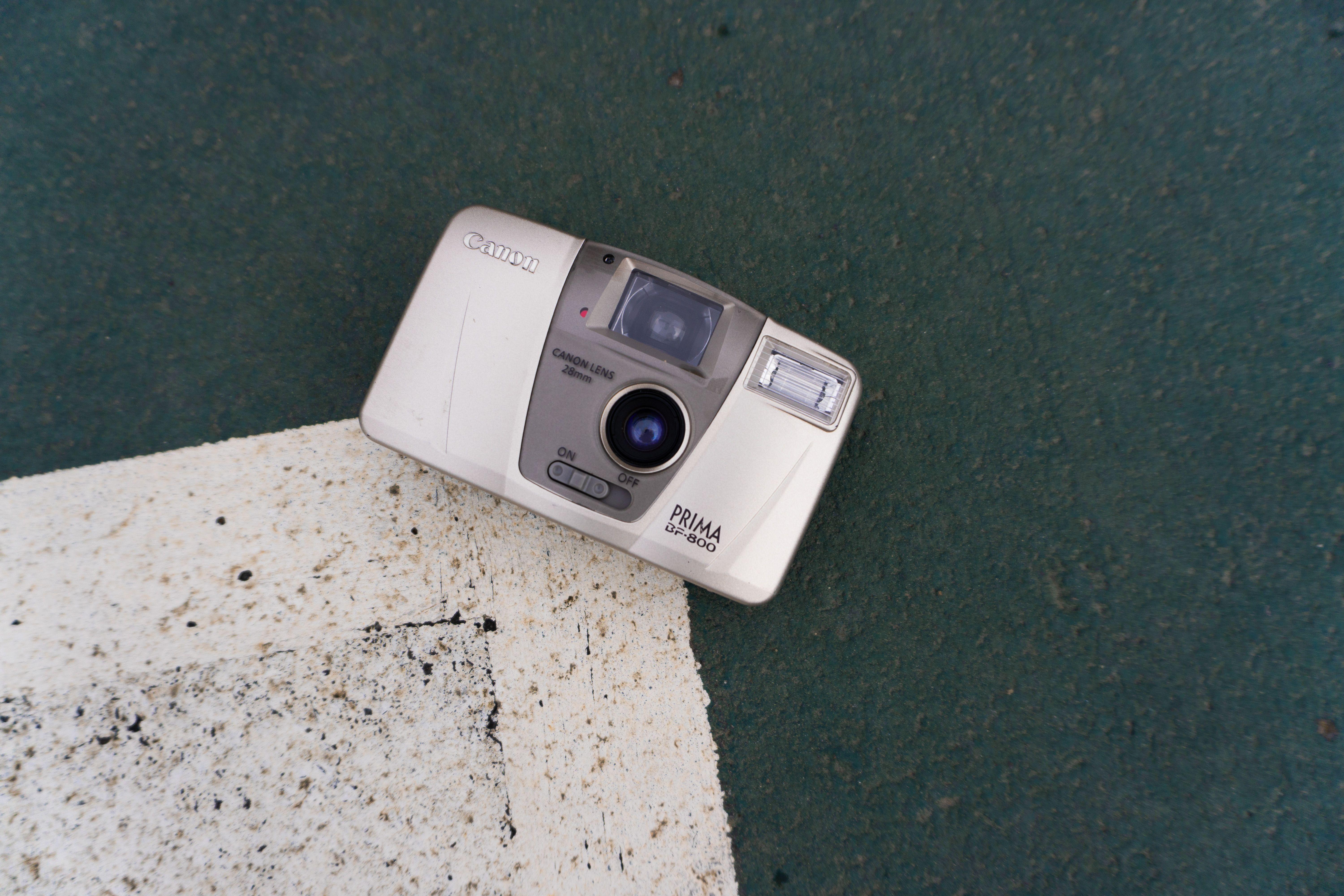 A classic Canon camera laying on a textured outdoor surface in Istanbul.